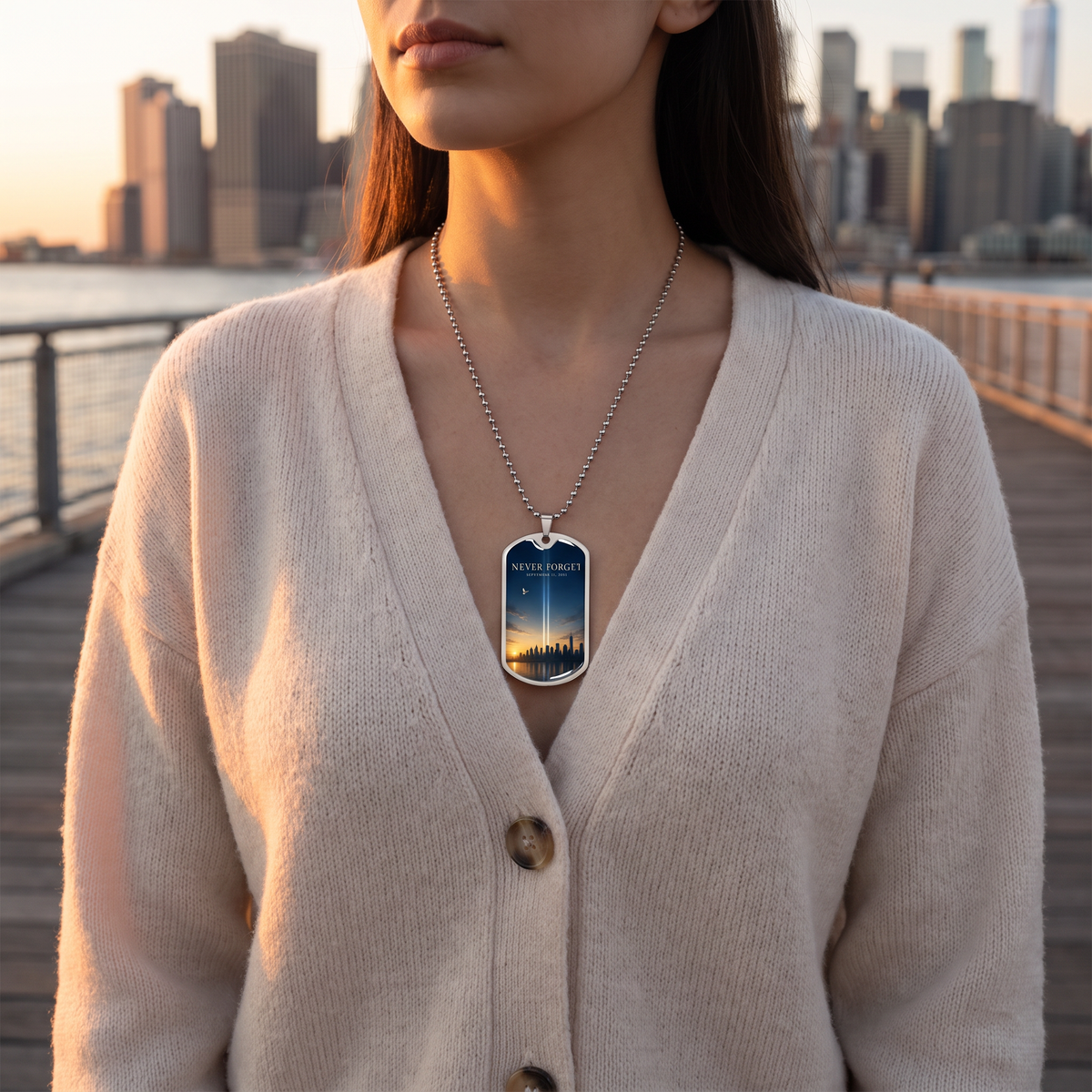 Woman wearing the Never Forget 9/11 NYC skyline dog tag necklace on a Brooklyn waterfront at sunset