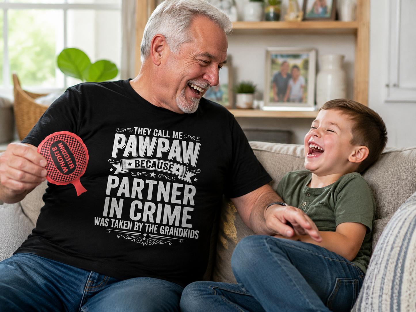 Grandpa wearing Pawpaw's Partner In Crime Premium Tee playing with grandkid in living room lifestyle image