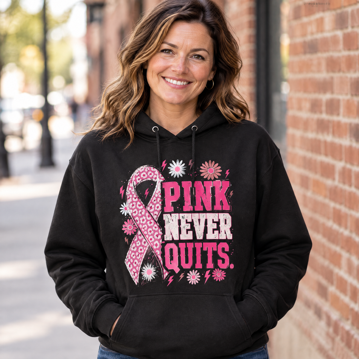 Woman wearing the Pink Never Quits breast cancer awareness hoodie