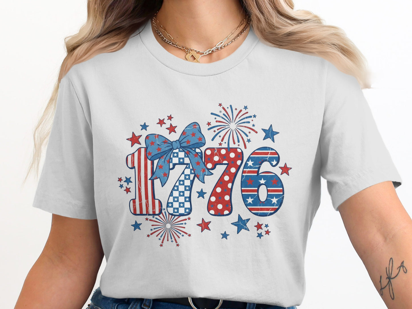 White t-shirt with red, white, and blue 1776 design and fireworks.