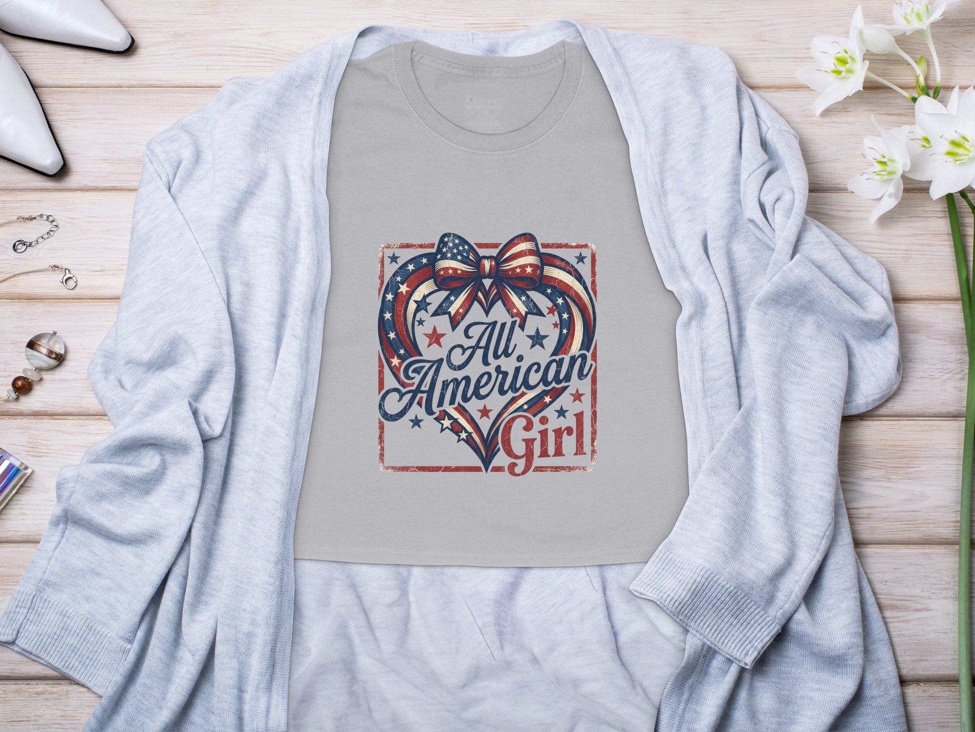 Gray t-shirt with "All American Girl" text and American flag heart design.