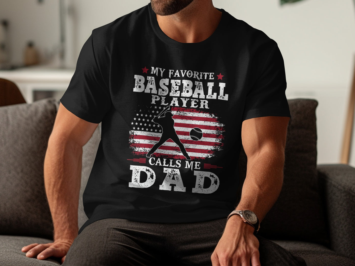 Black t-shirt with American flag, baseball, and text "MY FAVORITE BASEBALL PLAYER CALLS ME DAD".