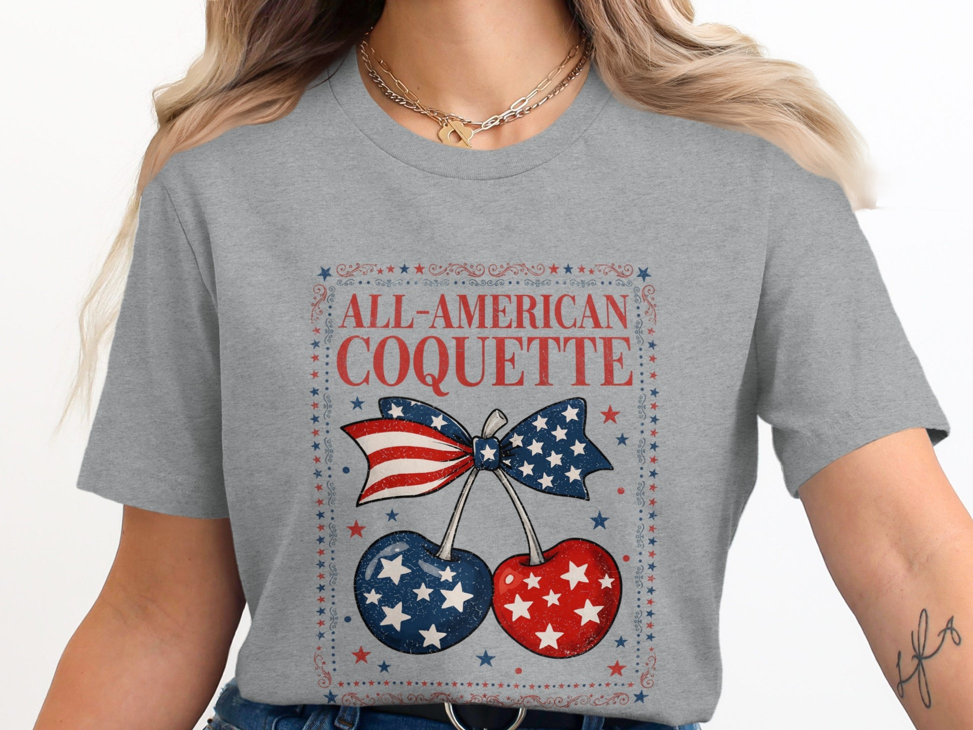 Grey t-shirt with "All-American Coquette" and cherries with US flag pattern.