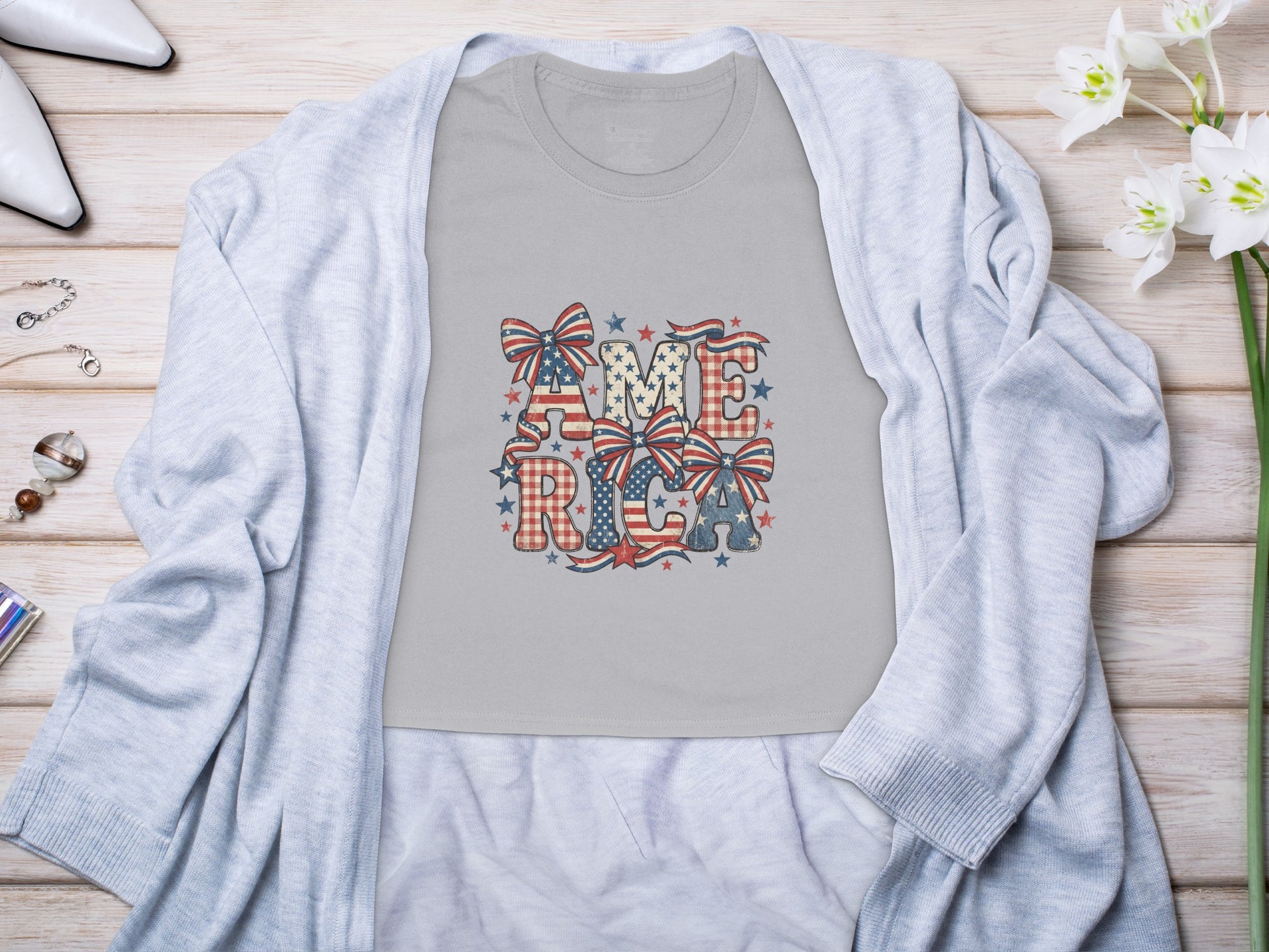 Gray t-shirt with "AMERICA" in patriotic font and patterns.
