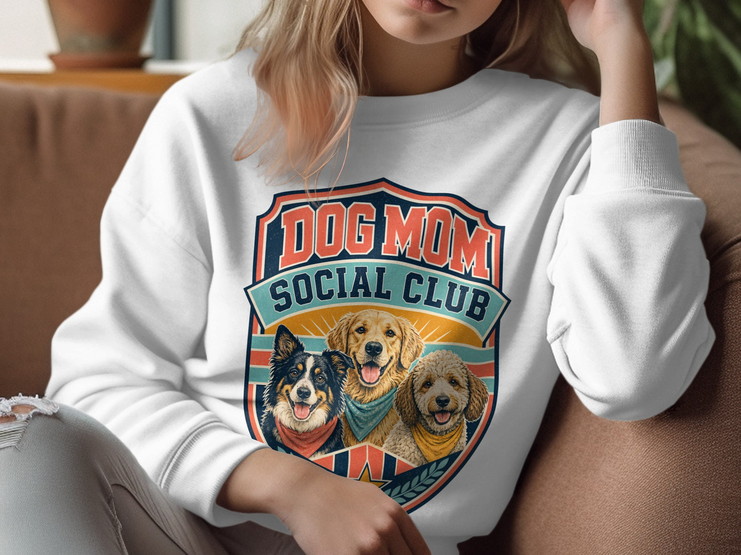 White sweatshirt with "Dog Mom Social Club" crest featuring three happy dogs.