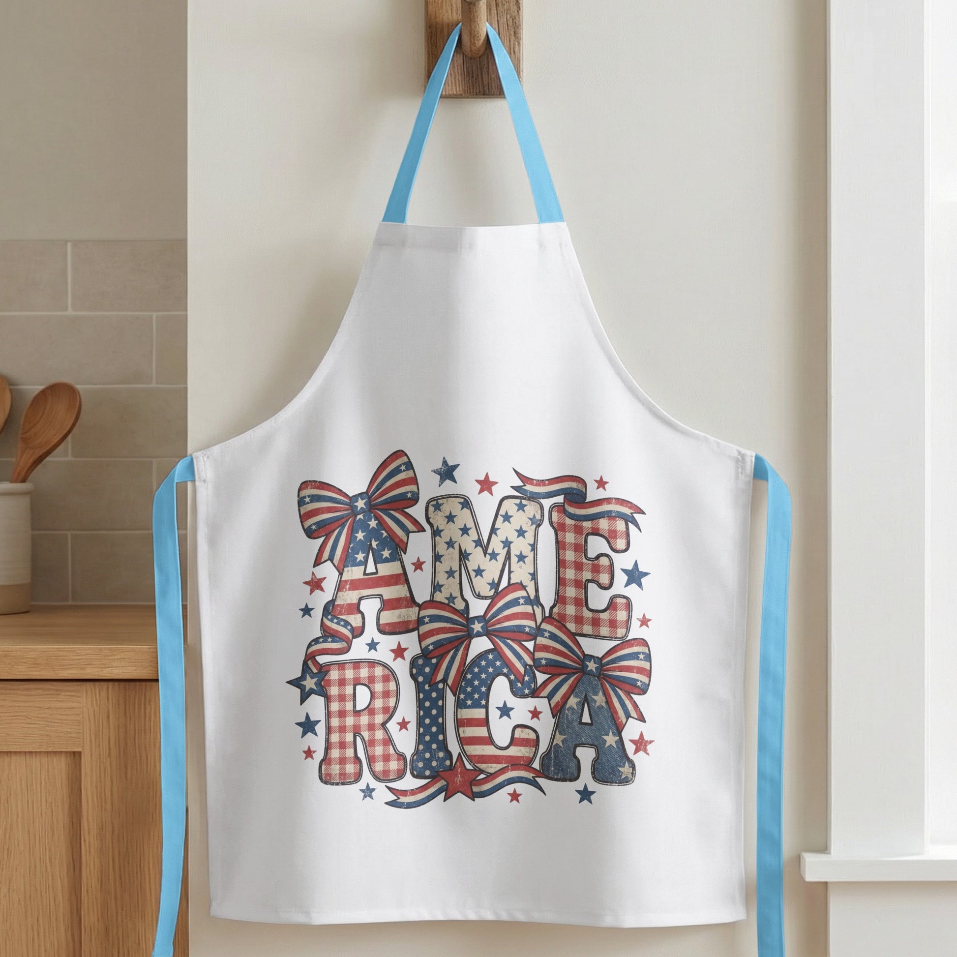 White apron with "AMERICA" text in patriotic distressed patterns and bows.
