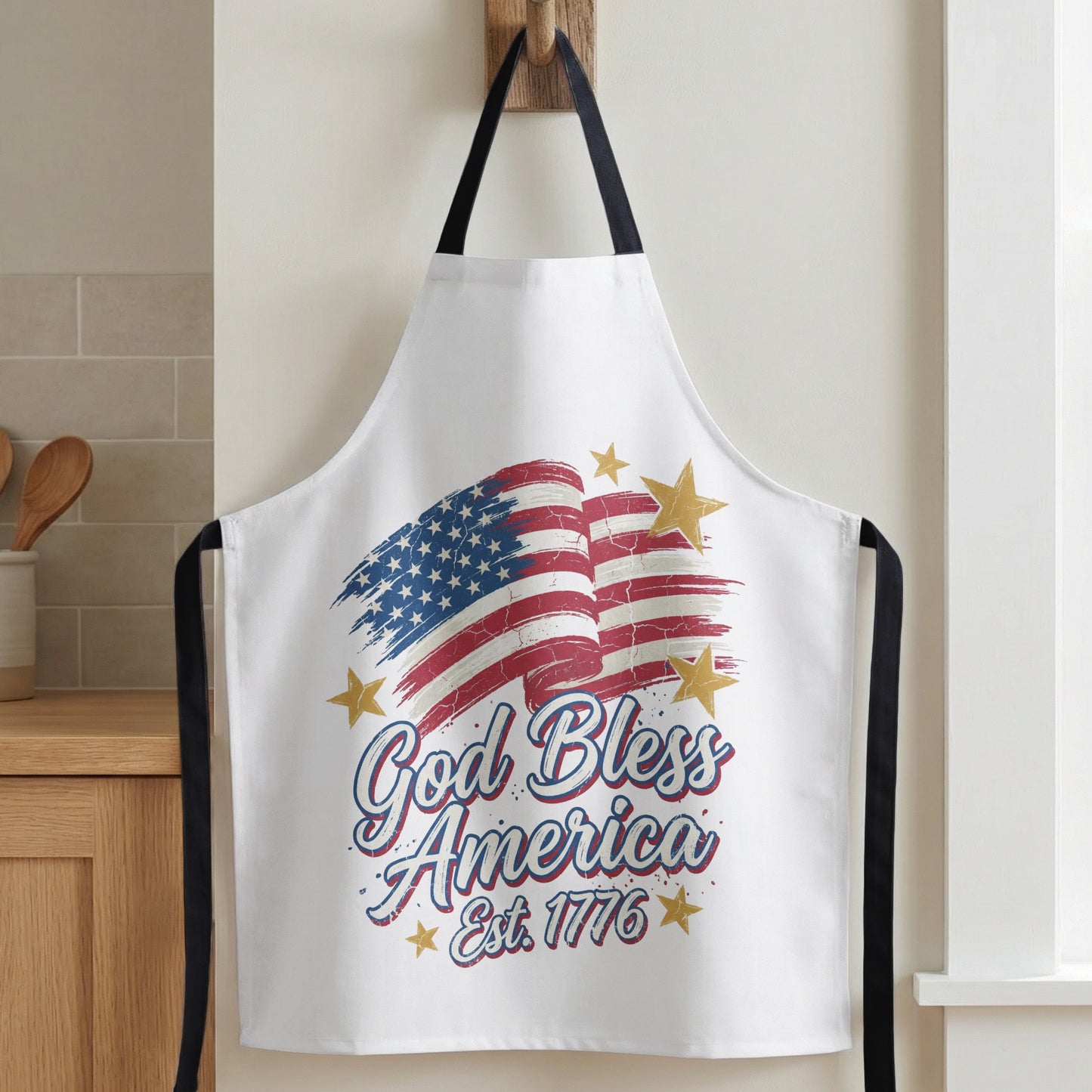 White apron with American flag design and "God Bless America Est. 1776" text.
