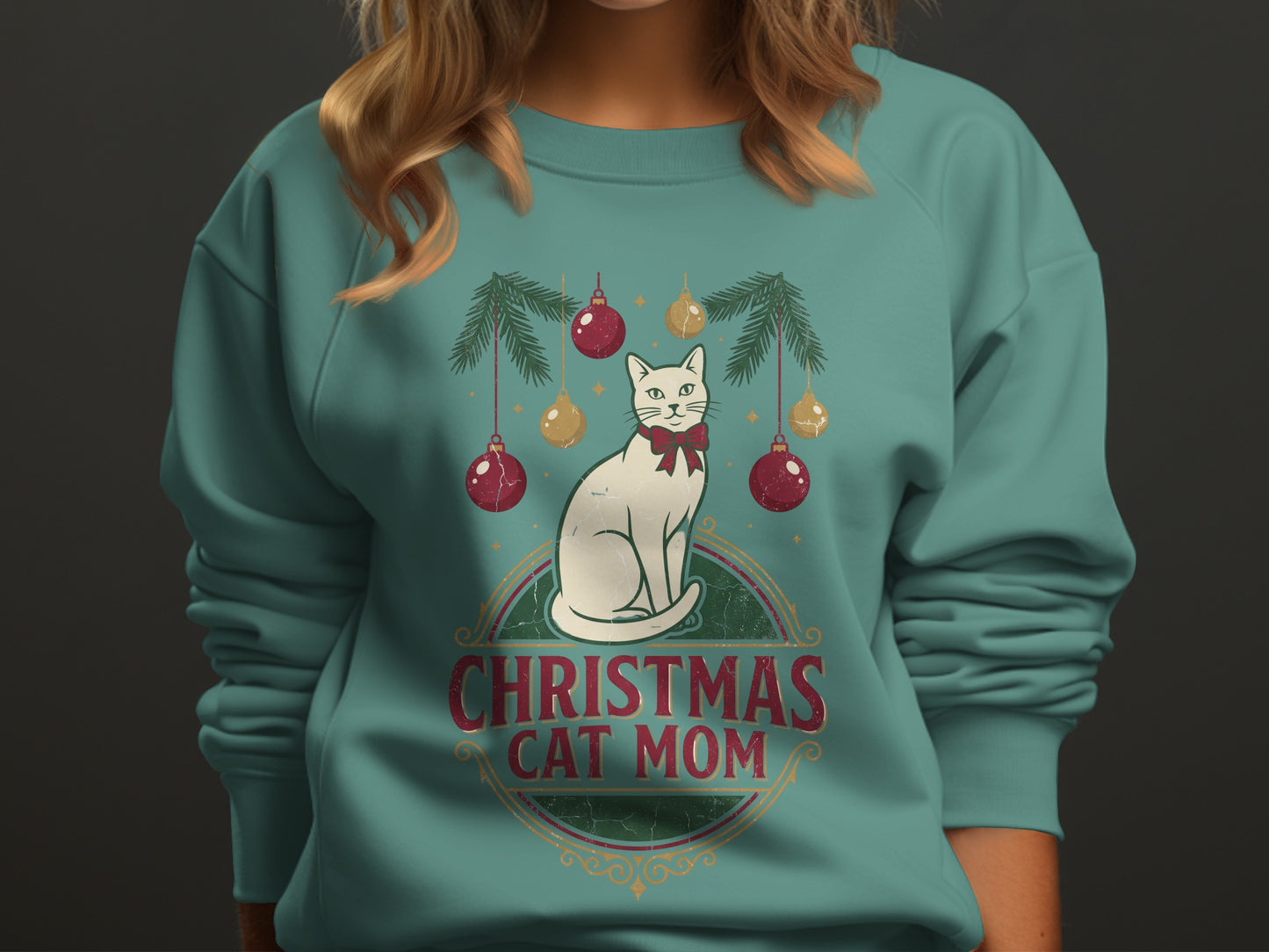 White cat with a red bow under Christmas ornaments and text "CHRISTMAS CAT MOM".