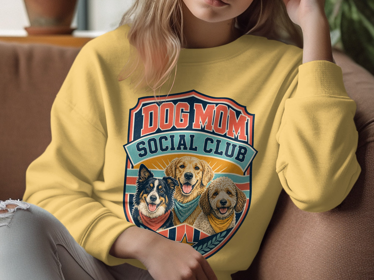 Yellow sweatshirt with a "Dog Mom Social Club" graphic featuring three dogs.