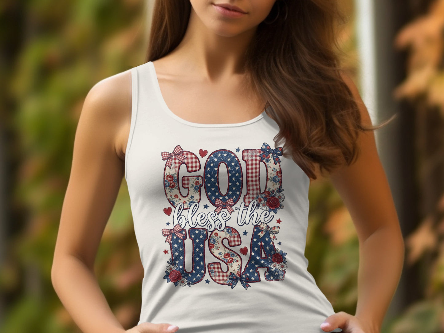 White tank top with "GOD bless the USA" text in patriotic patterns and floral accents.