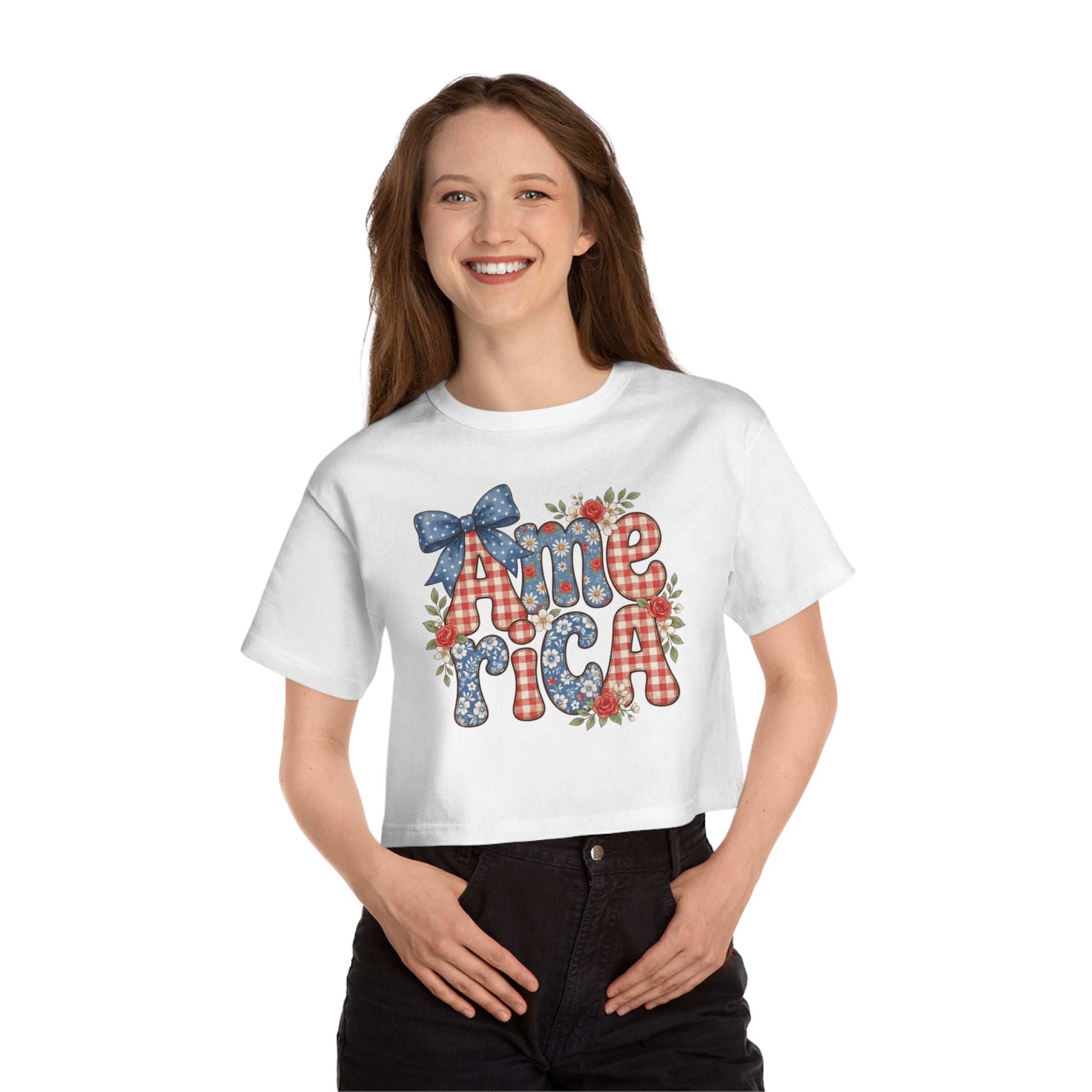 White crop top with "America" text design featuring patriotic patterns and floral accents.