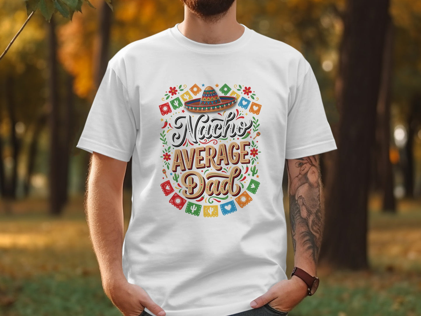 White t-shirt with colorful "Nacho Average Dad" text and sombrero graphic.