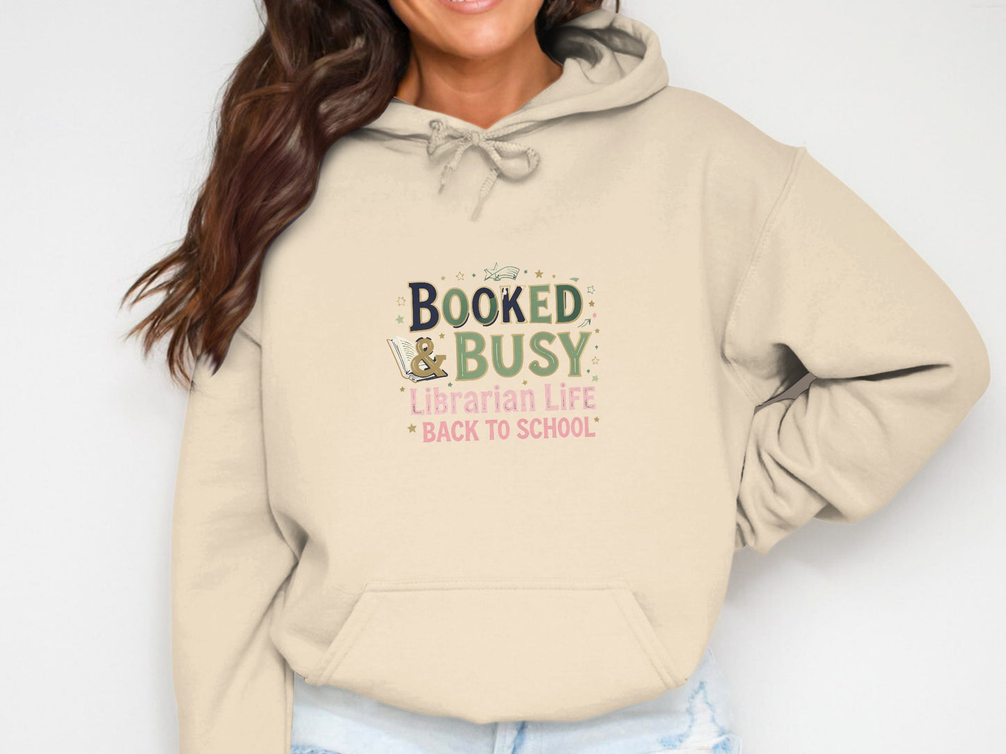 Beige hoodie with "Booked & Busy Librarian Life Back to School" graphic.