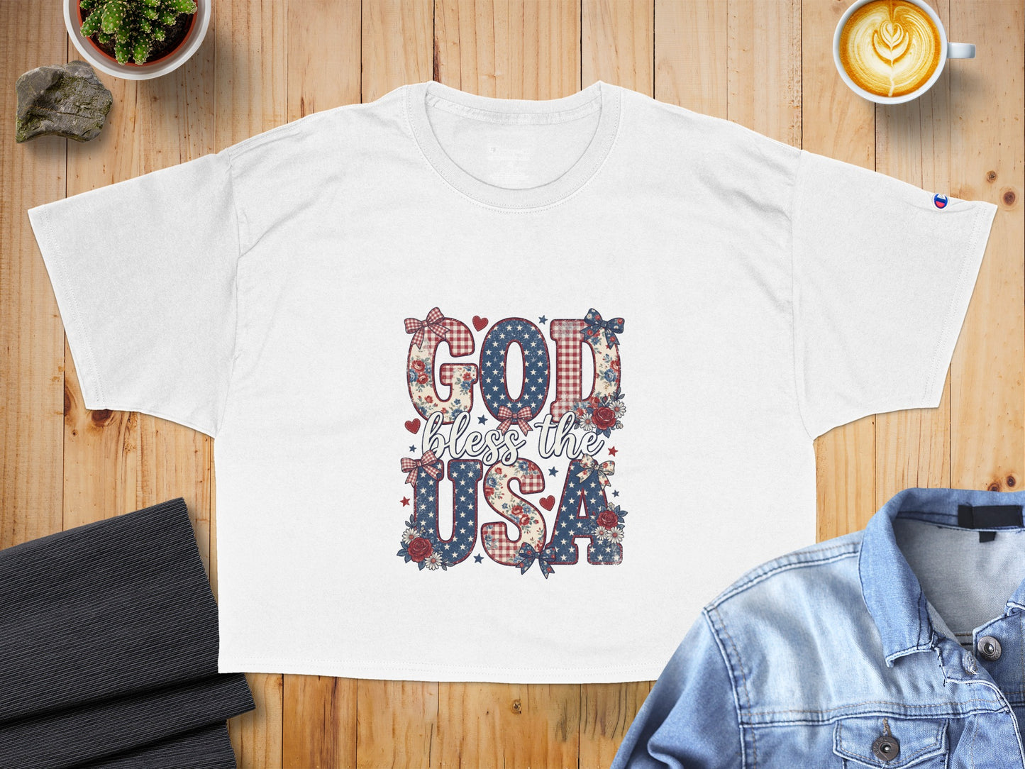 White t-shirt with "God Bless the USA" graphic in patriotic patterns.