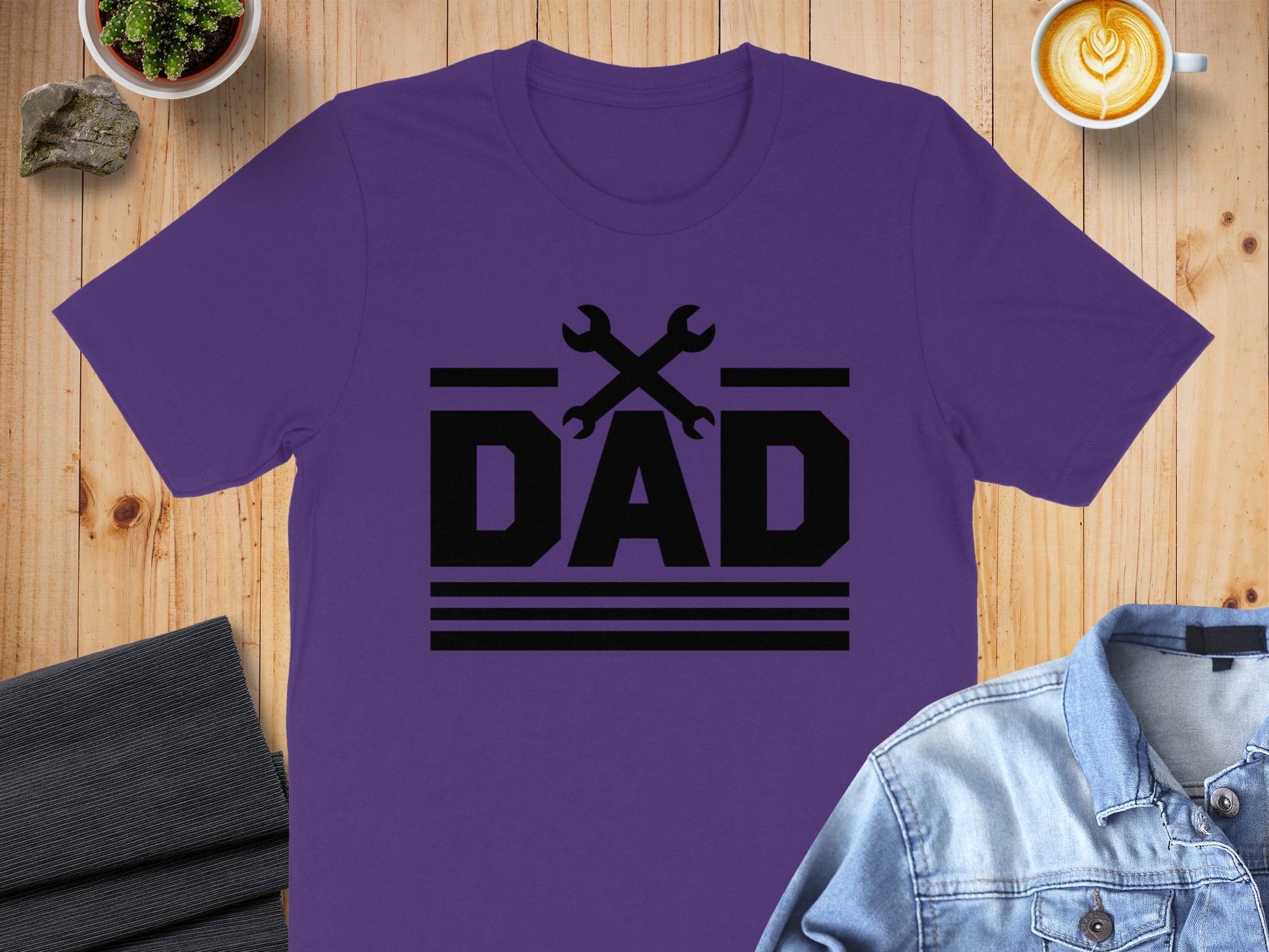 Purple t-shirt with black "DAD" text and crossed wrenches graphic.