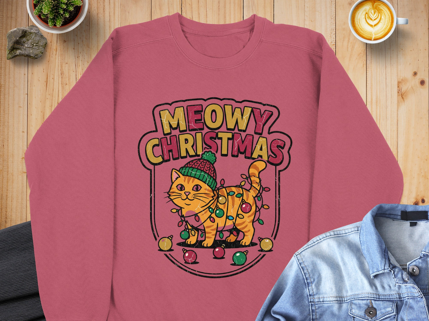 Crewneck sweatshirt with a graphic of a cat wrapped in Christmas lights.