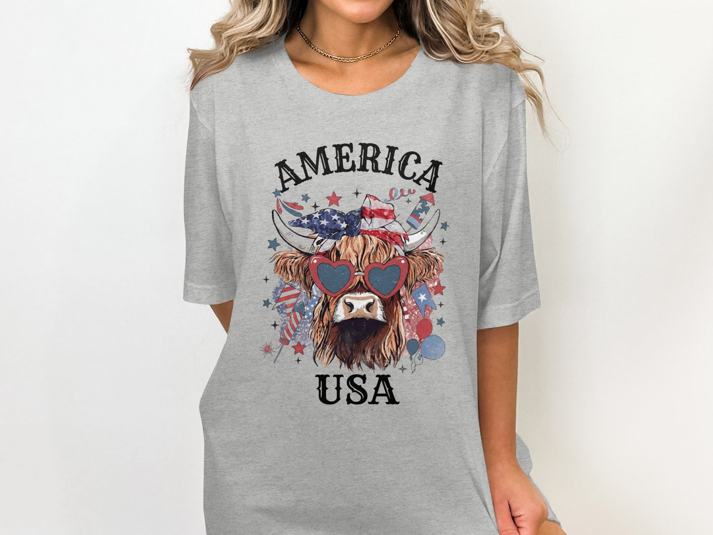 Grey t-shirt with a patriotic cow wearing heart sunglasses and a bandana.