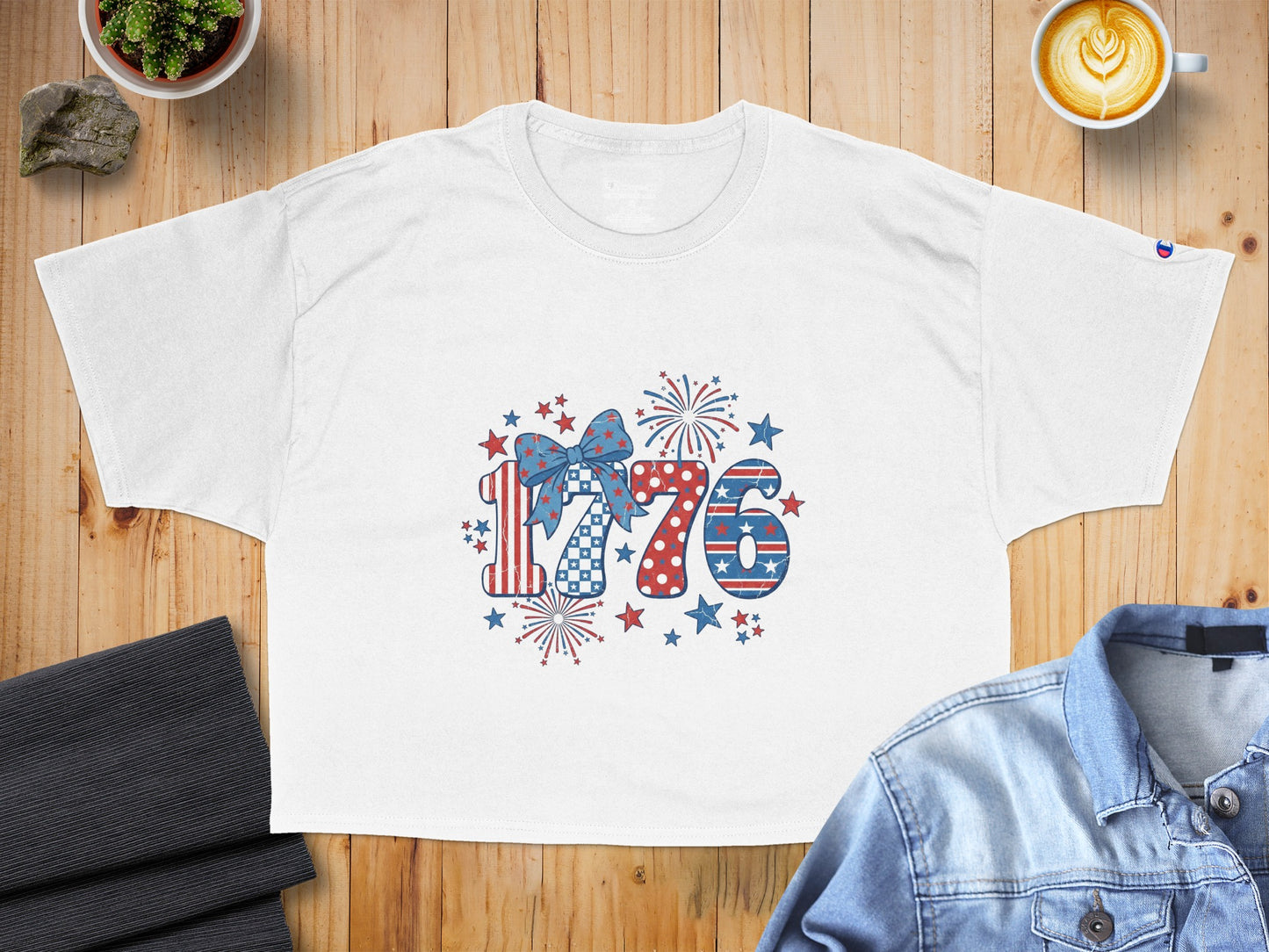 White t-shirt with patriotic "1776" graphic including fireworks and stars.