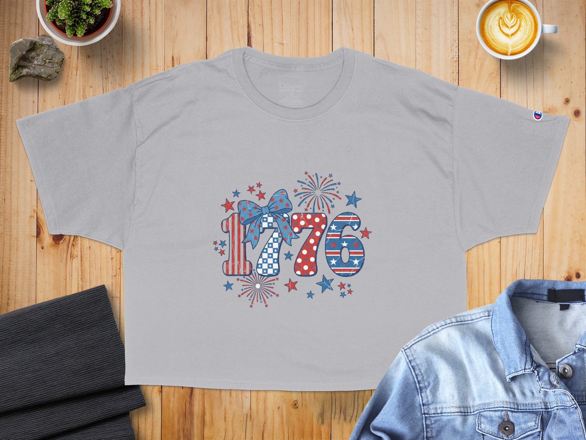 Grey t-shirt with "1776" graphic featuring American flag patterns and fireworks.