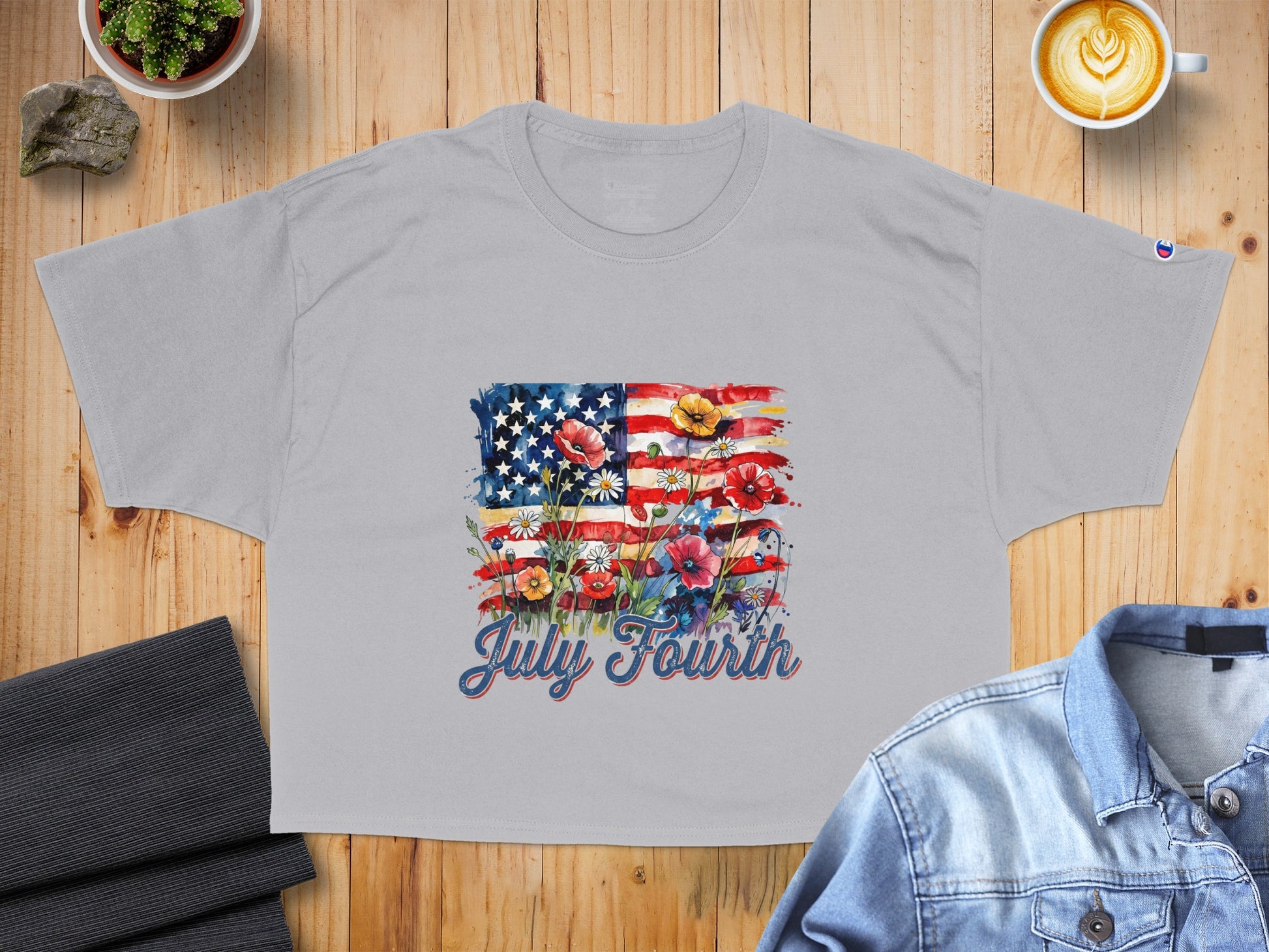 Light grey t-shirt with American flag and flowers graphic, reads "July Fourth."
