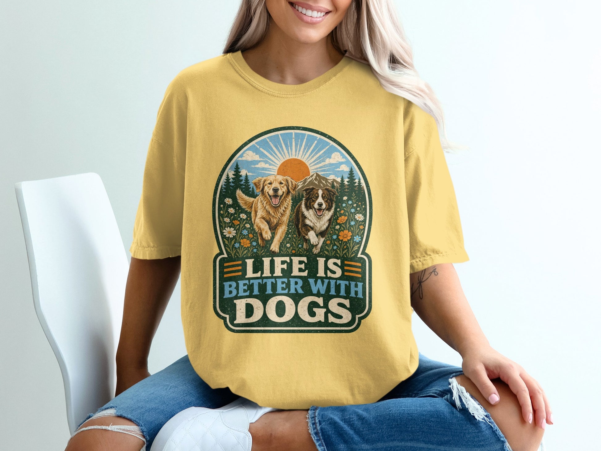 Yellow t-shirt with graphic of two dogs, mountains, and text "Life is Better With Dogs".