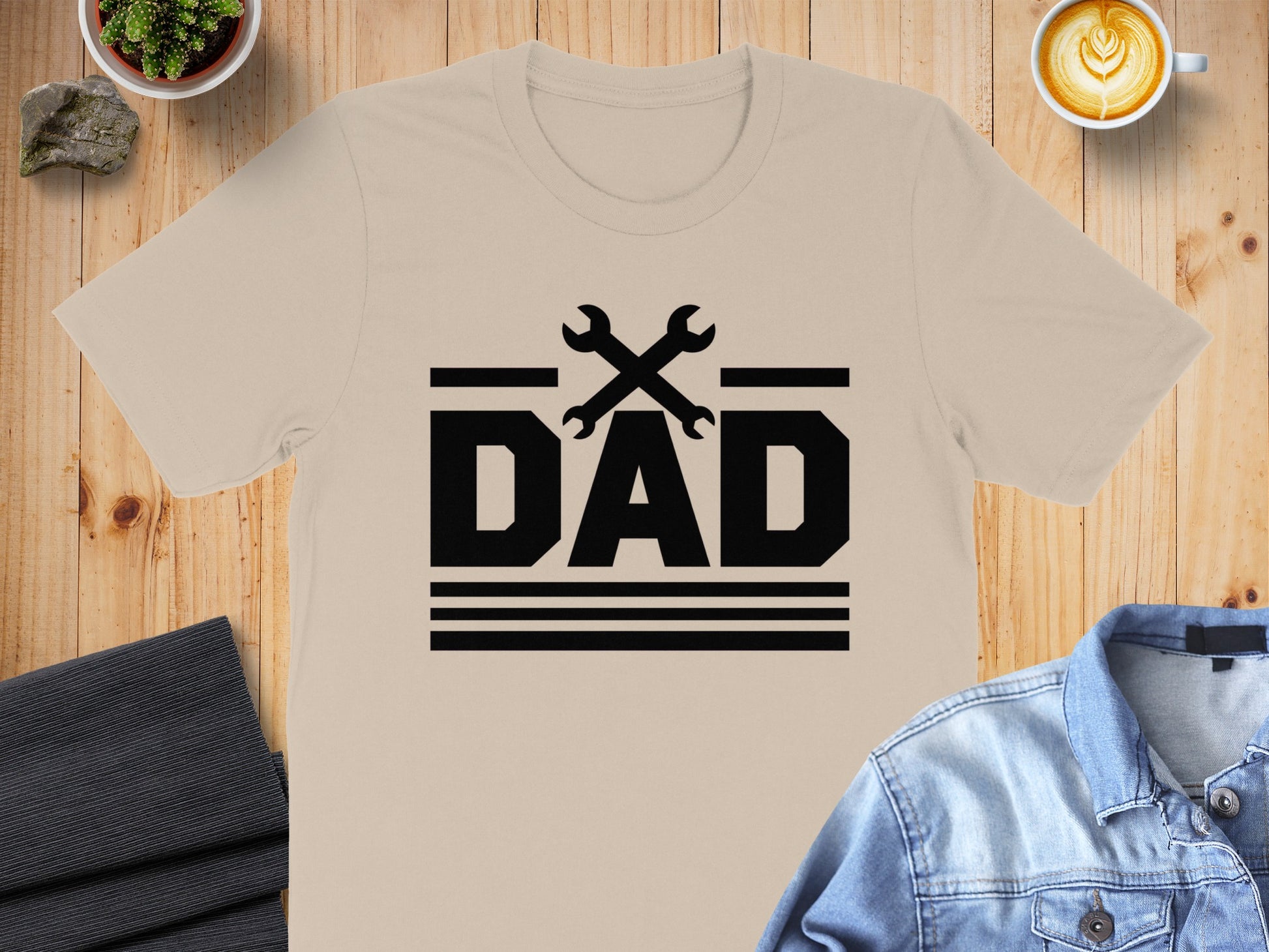Black "DAD" text with crossed wrenches above and horizontal lines below.