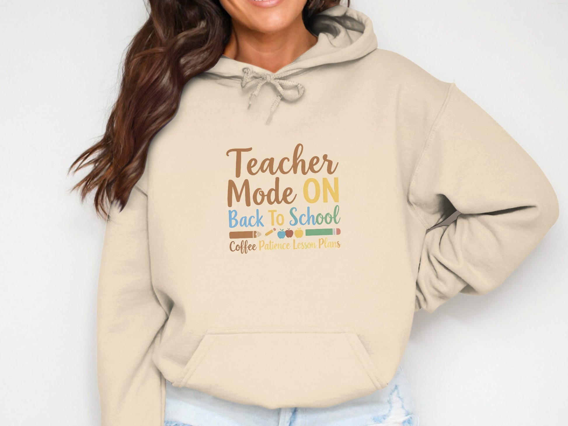 Beige hoodie with "Teacher Mode ON Back To School" and graphics.