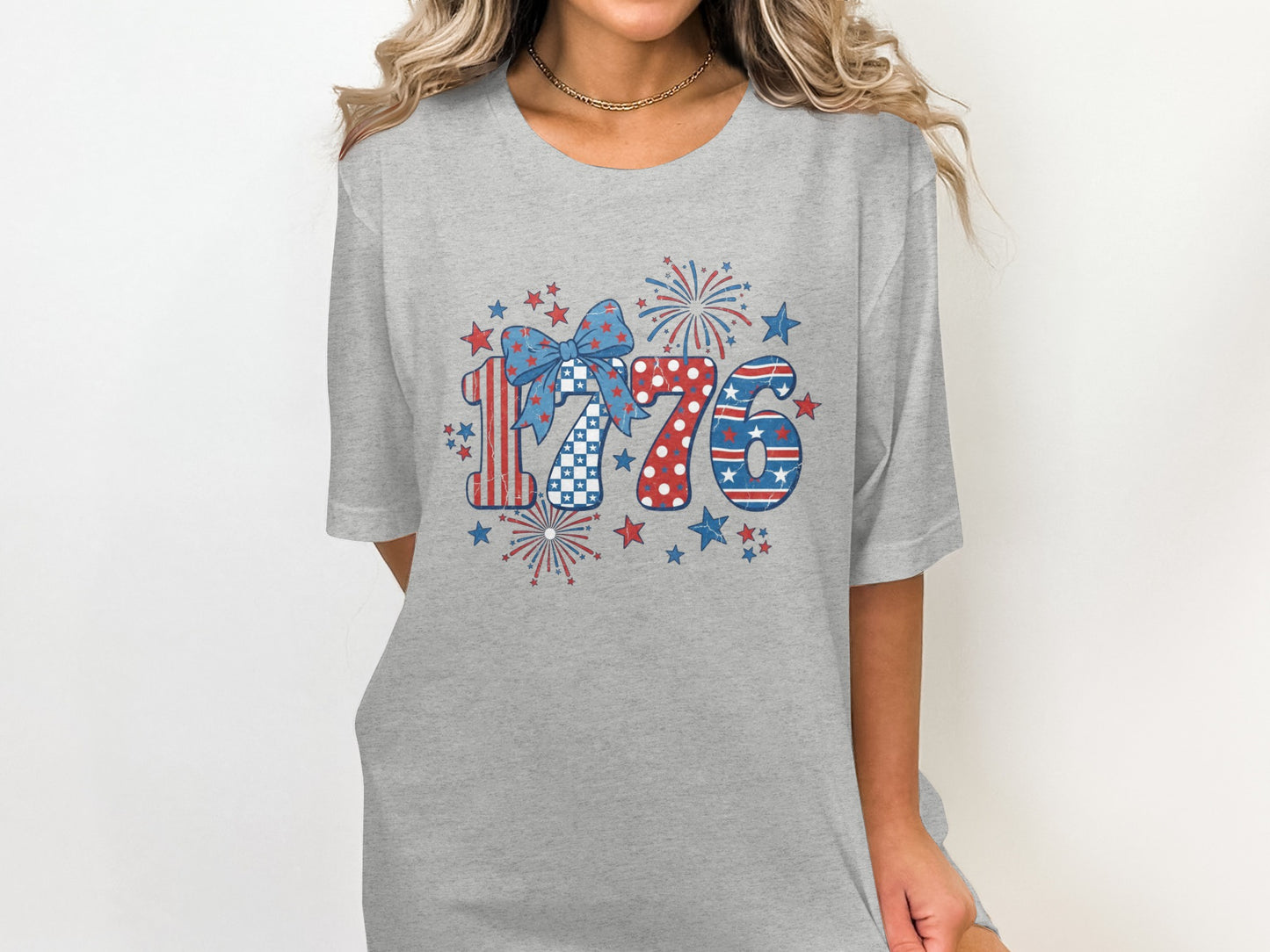 Gray t-shirt with red, white, and blue 1776 graphic and fireworks.