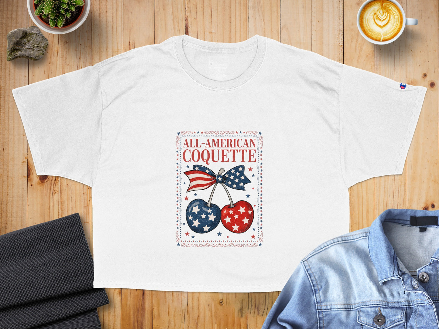 White t-shirt with "ALL-AMERICAN COQUETTE" and patriotic cherries graphic.
