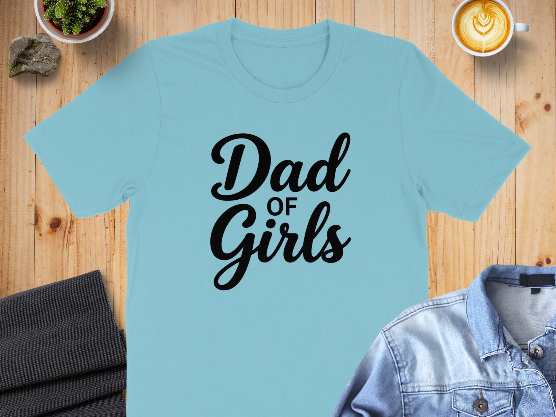 Light blue t-shirt with "Dad of Girls" text in black.