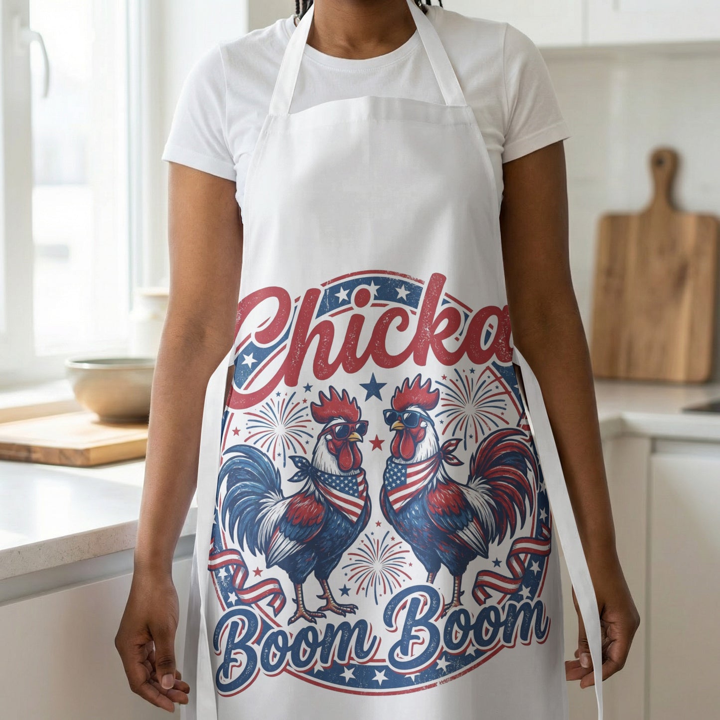 White apron with roosters wearing sunglasses and American flag bandanas, text "Chicka Boom Boom".