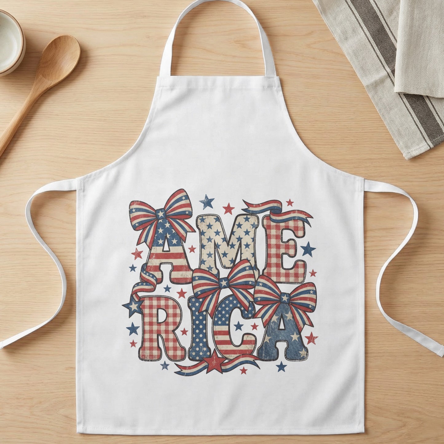 White apron with "AMERICA" spelled out in distressed patriotic patterns and bows.