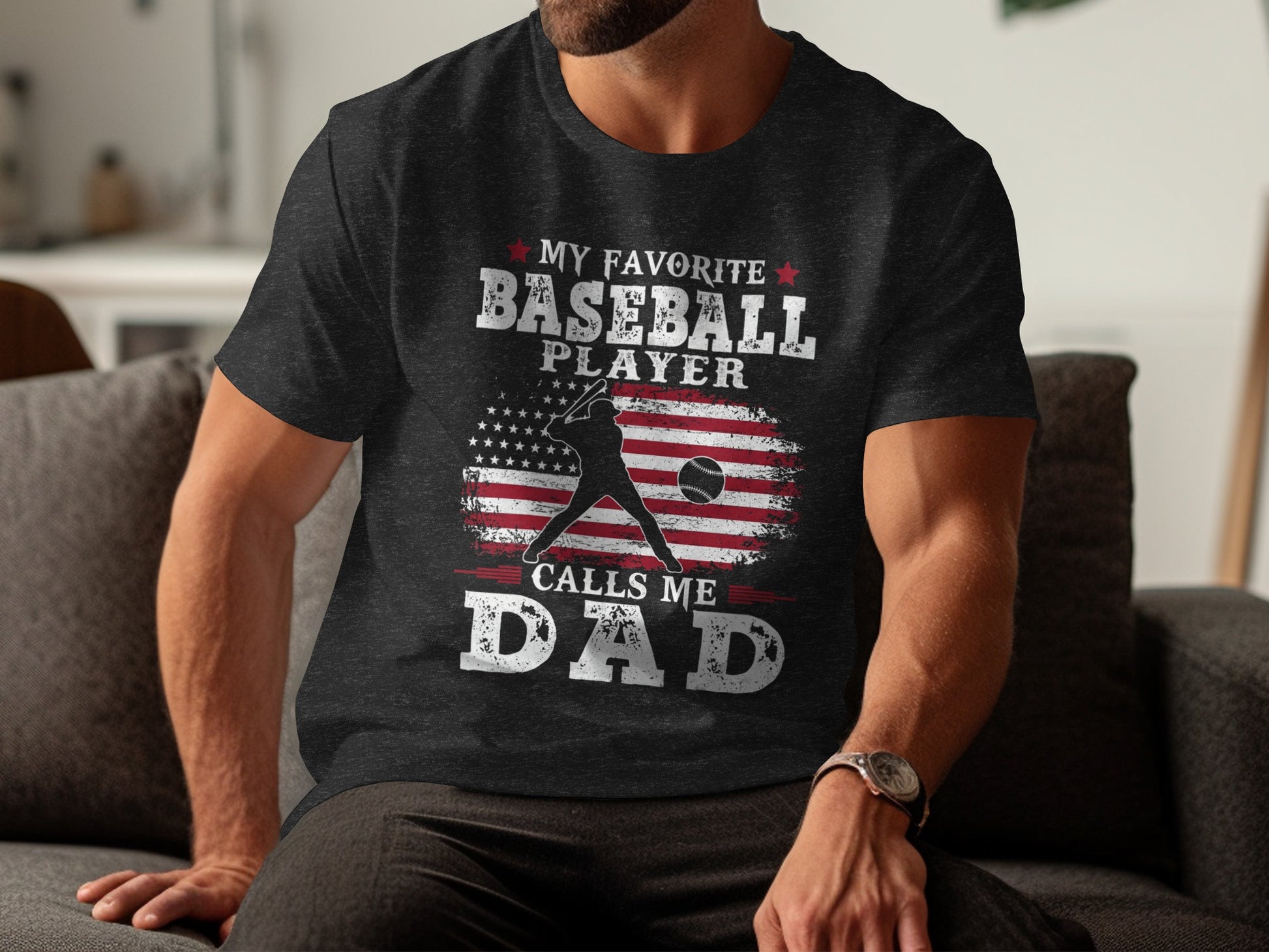 Black t-shirt with "My Favorite Baseball Player Calls Me Dad" and American flag graphic.