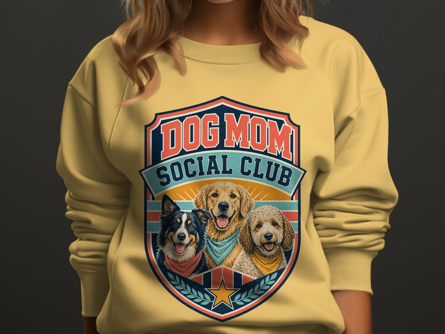 Yellow sweatshirt with "DOG MOM SOCIAL CLUB" logo featuring three dogs.