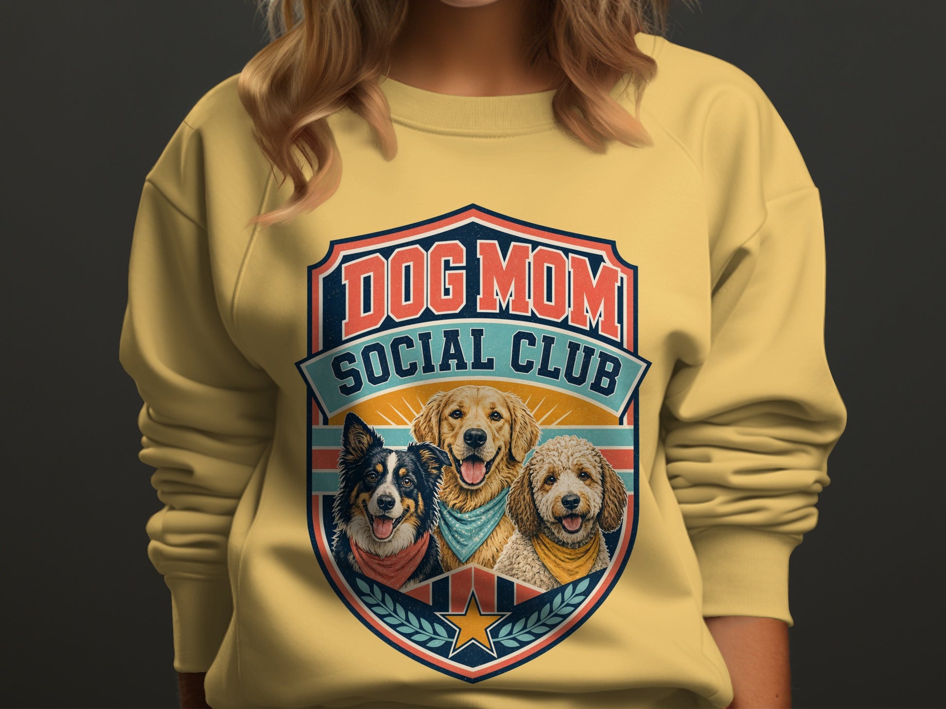 Yellow sweatshirt with "DOG MOM SOCIAL CLUB" logo featuring three dogs.