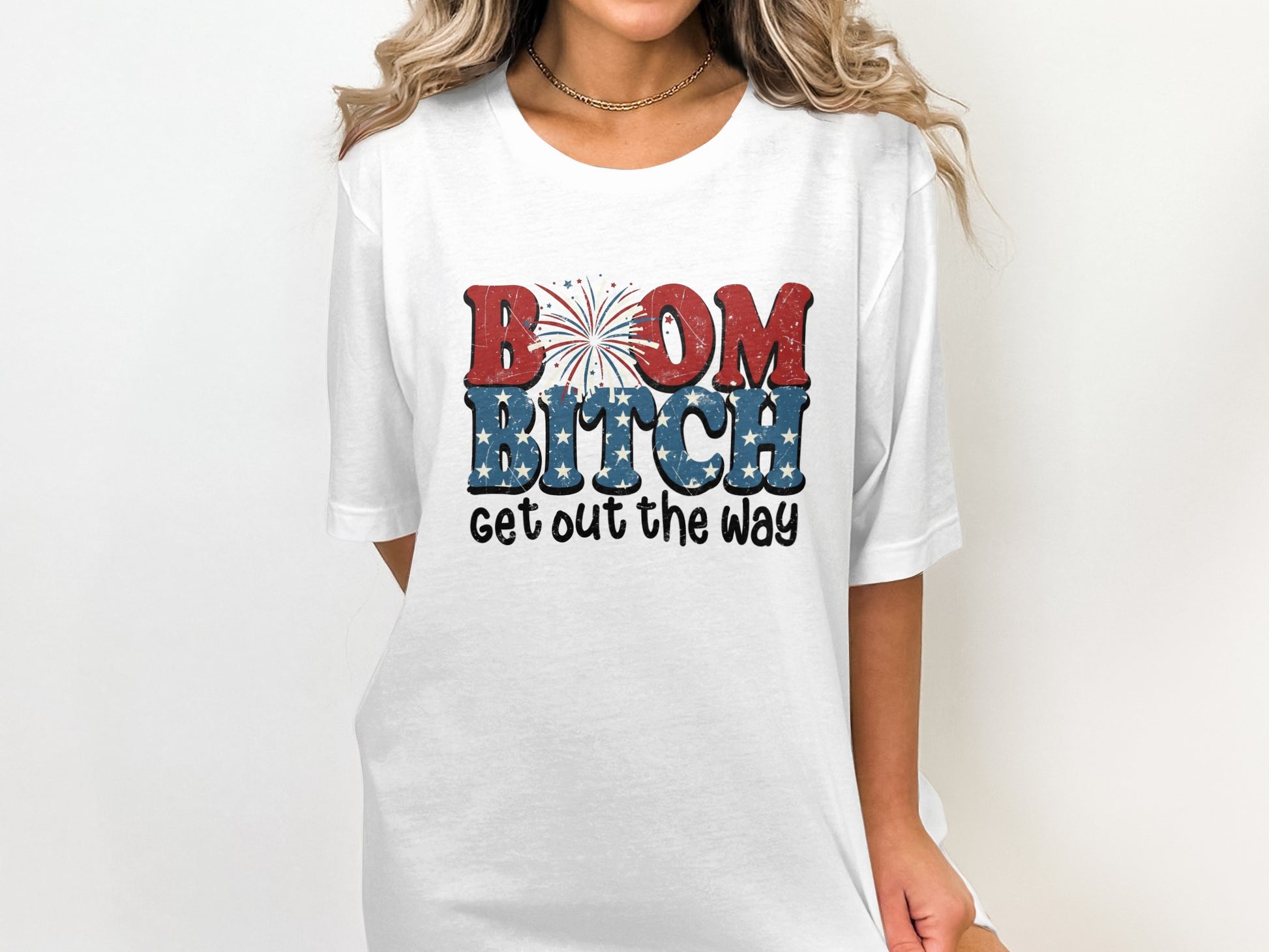 White t-shirt with "BOOM BITCH GET OUT THE WAY" graphic in patriotic colors.