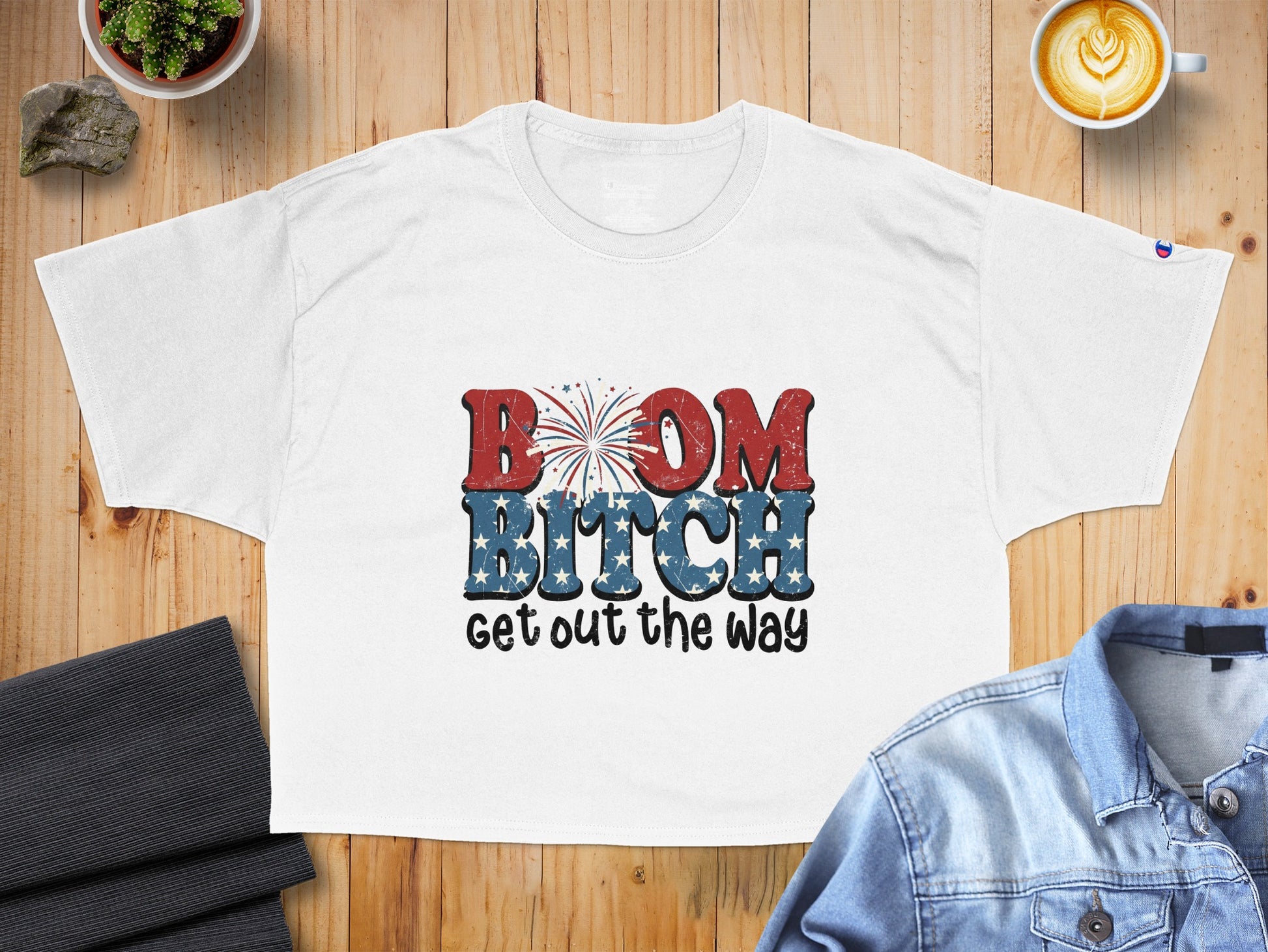 White t-shirt with red, white, and blue text "BOOM BITCH get out the way."
