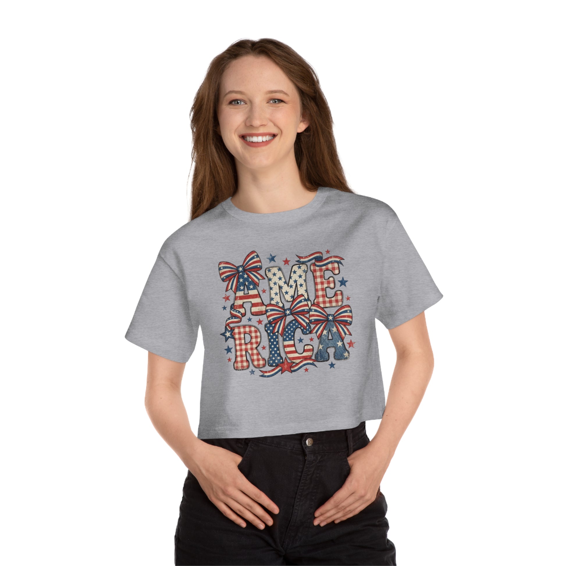 Woman in gray t-shirt with "AMERICA" in patriotic colors and bows.