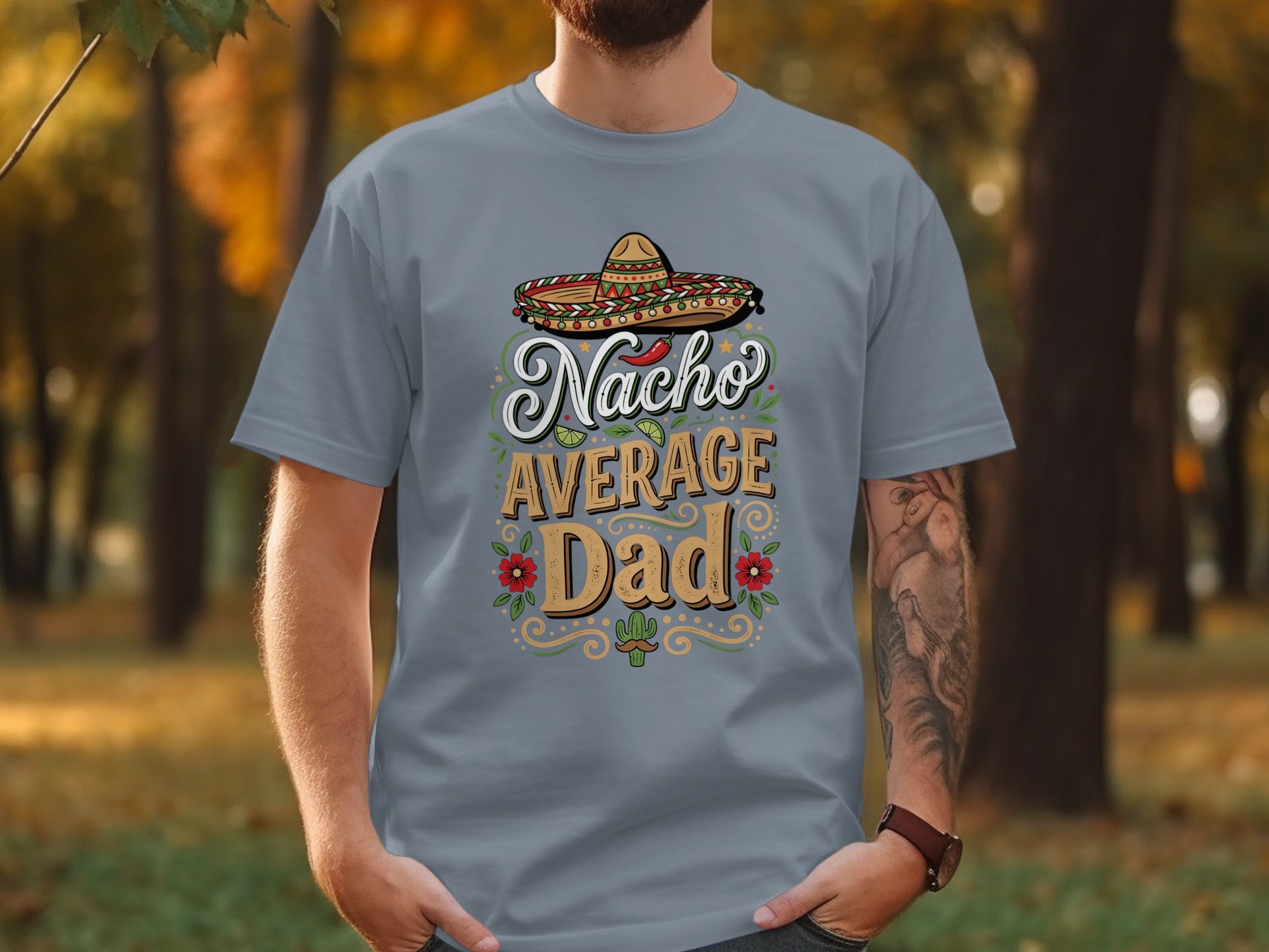 Nacho Average Dad text with sombrero and floral accents on gray t-shirt.