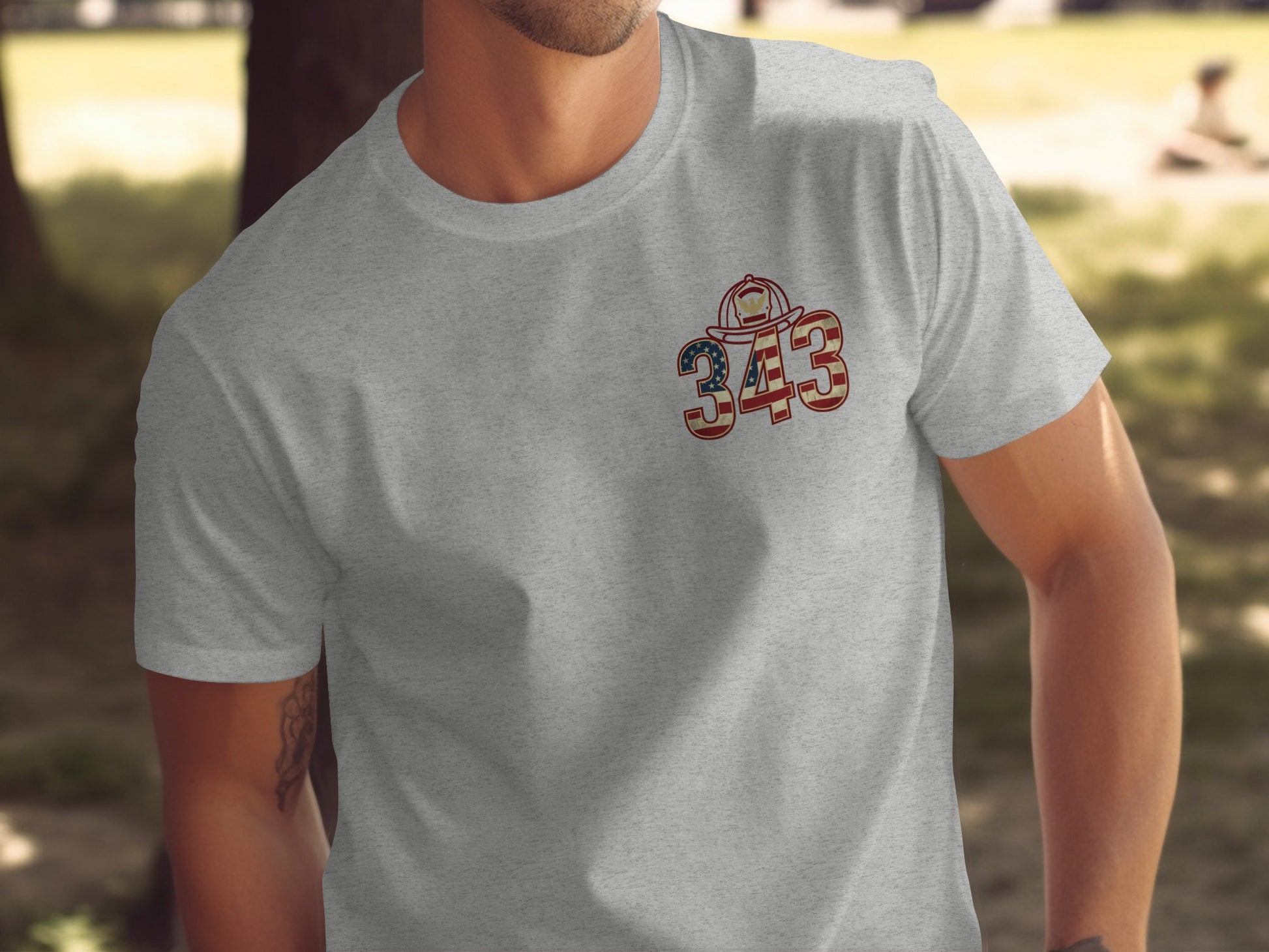 Grey t-shirt with a US flag-themed firefighter helmet and "343" graphic.