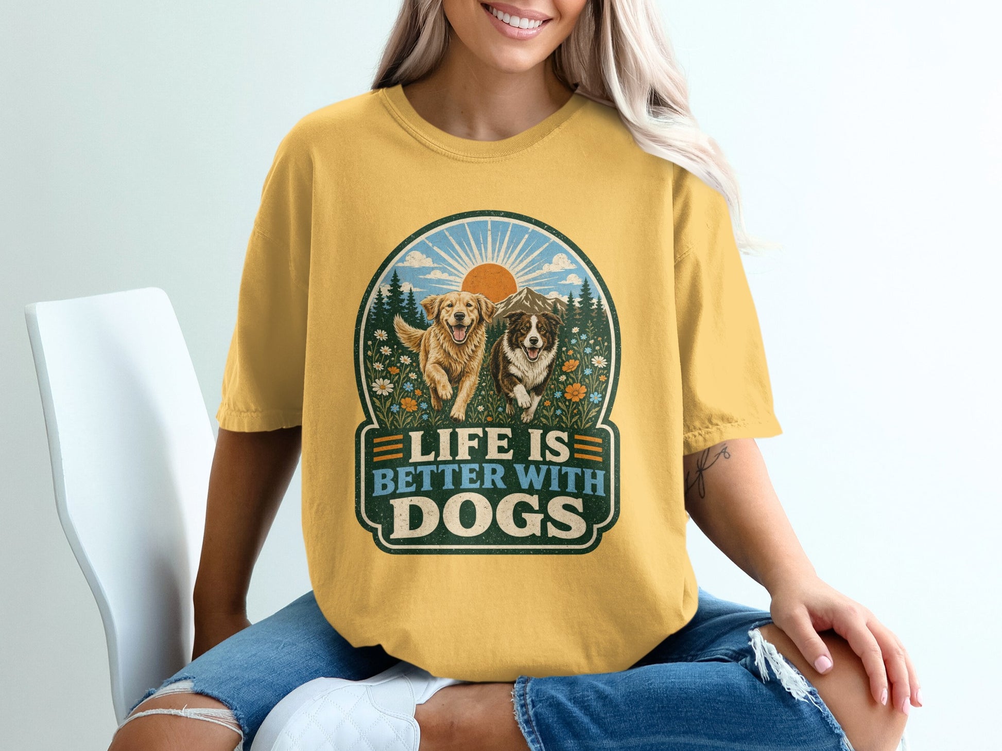 Yellow t-shirt graphic with two dogs, mountains, and text "Life is Better With Dogs."