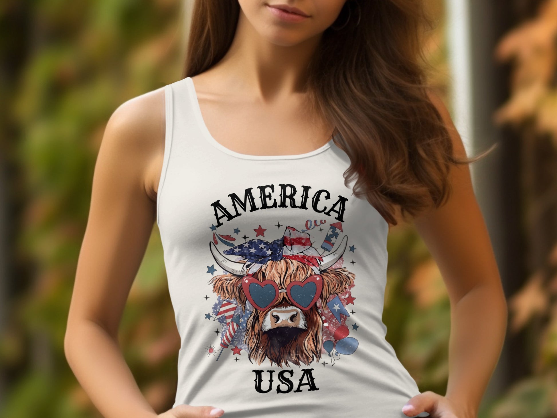 White tank top with Highland cow graphic, "AMERICA USA" text, and patriotic elements.