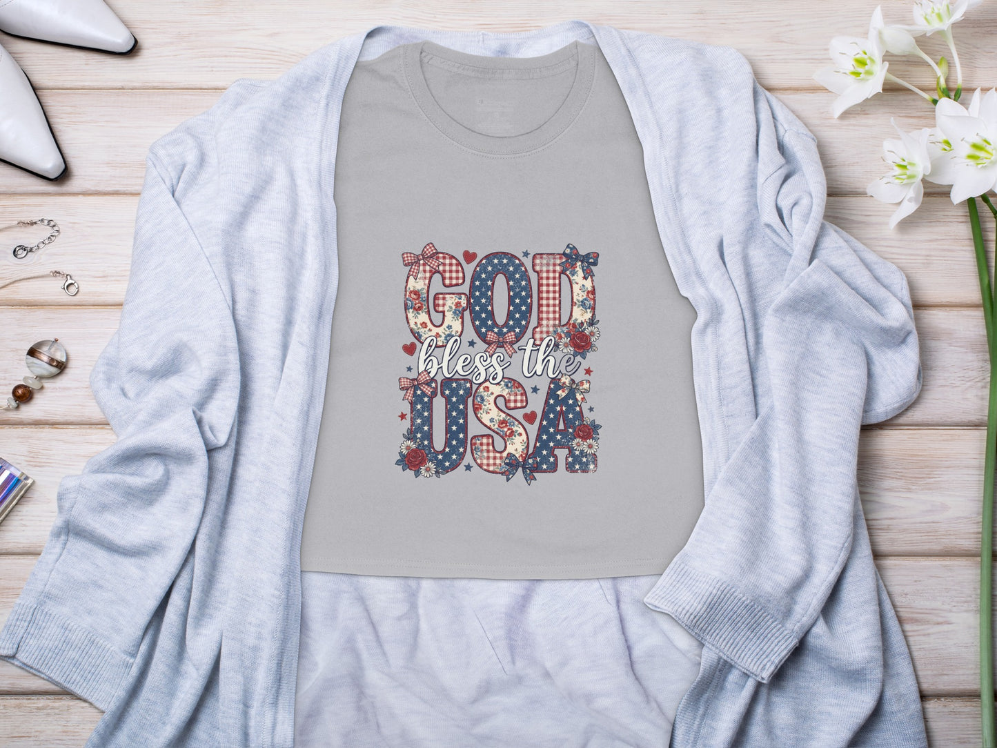 Grey t-shirt with "GOD bless the USA" in patriotic themed letters.