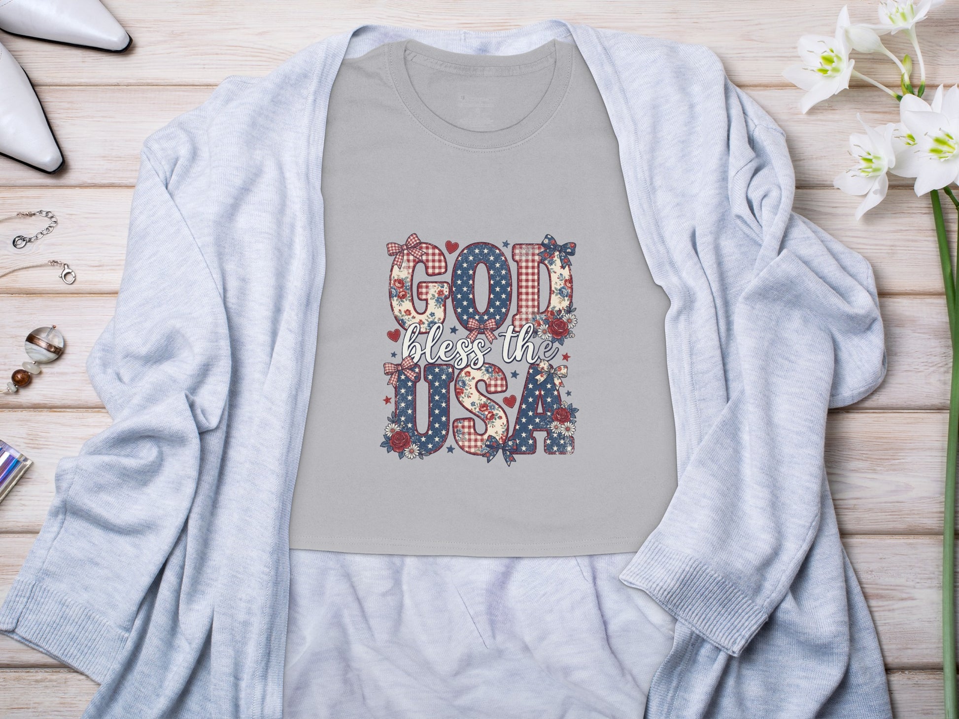 Grey t-shirt with "GOD bless the USA" in patriotic themed letters.