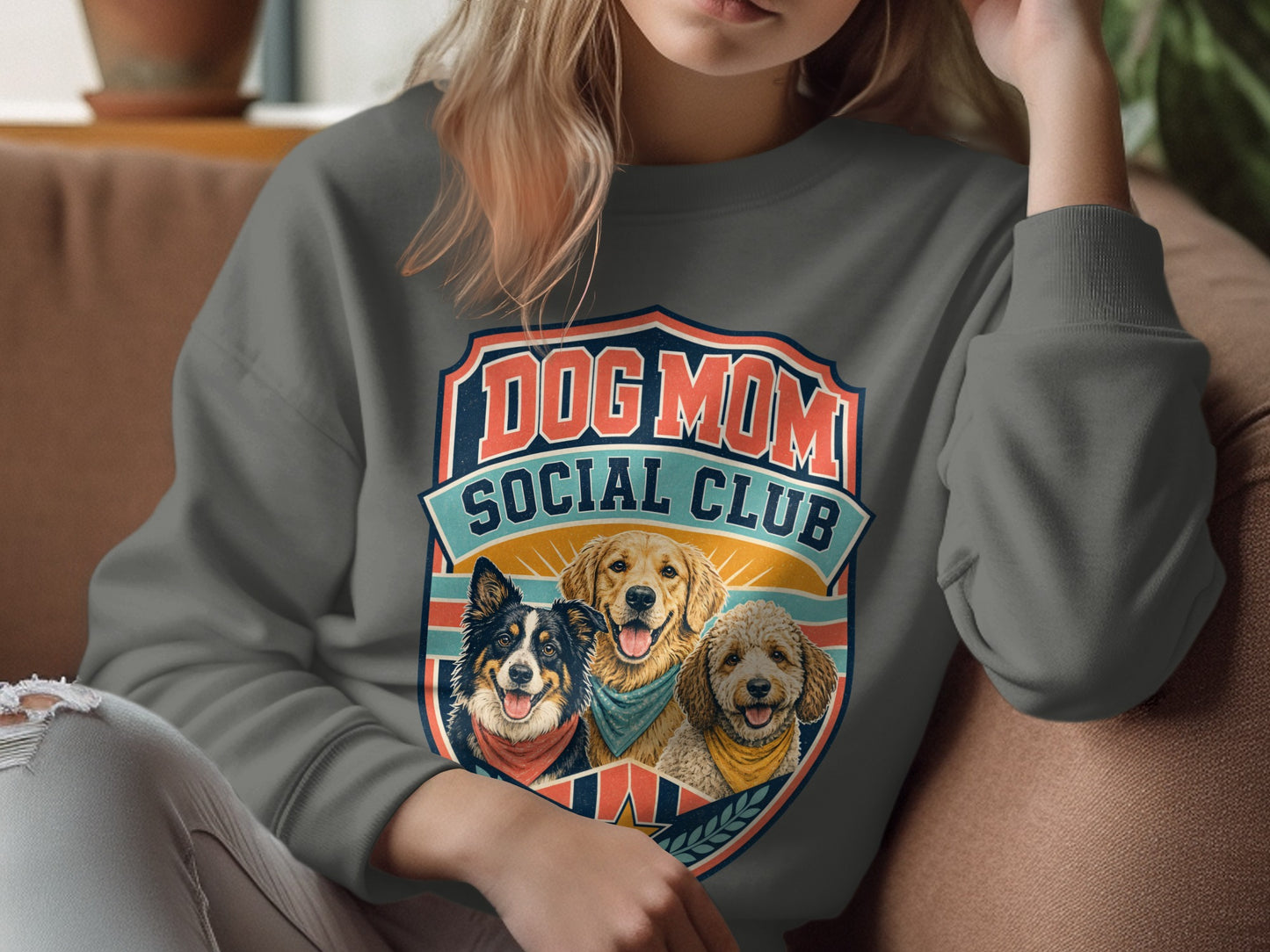 Graphic sweatshirt with "Dog Mom Social Club" text and three dogs in a crest.