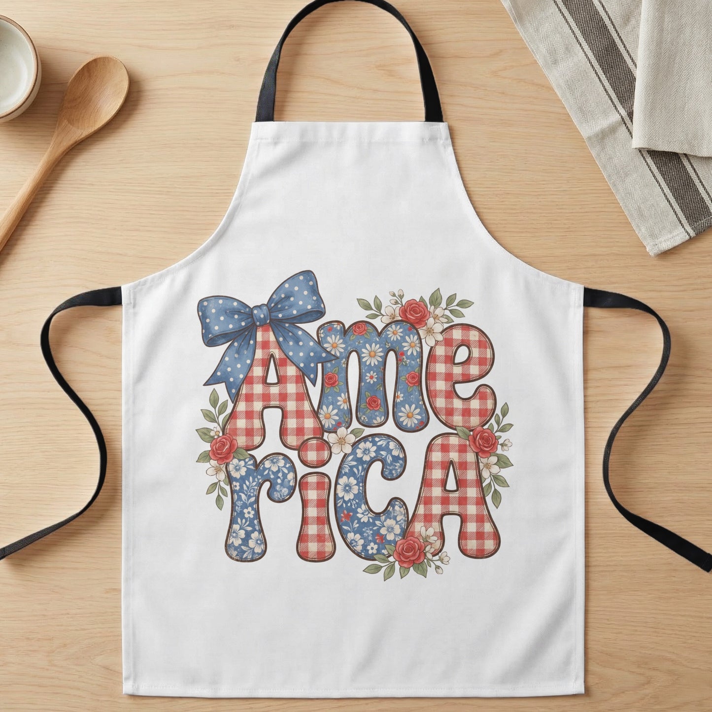 White apron with "America" text in red gingham and floral patterns, with bow.