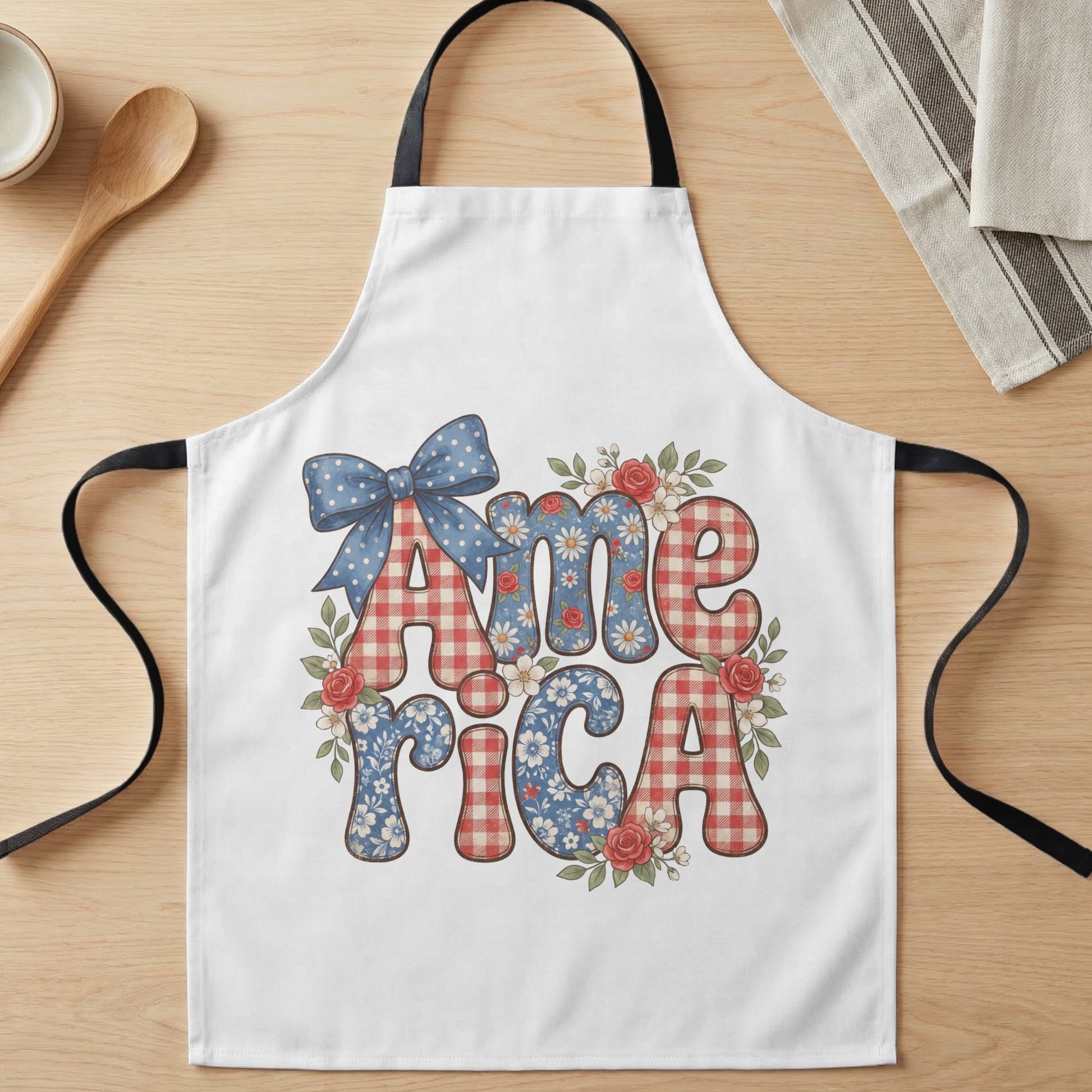 White apron with "America" text in red gingham and floral patterns, with bow.
