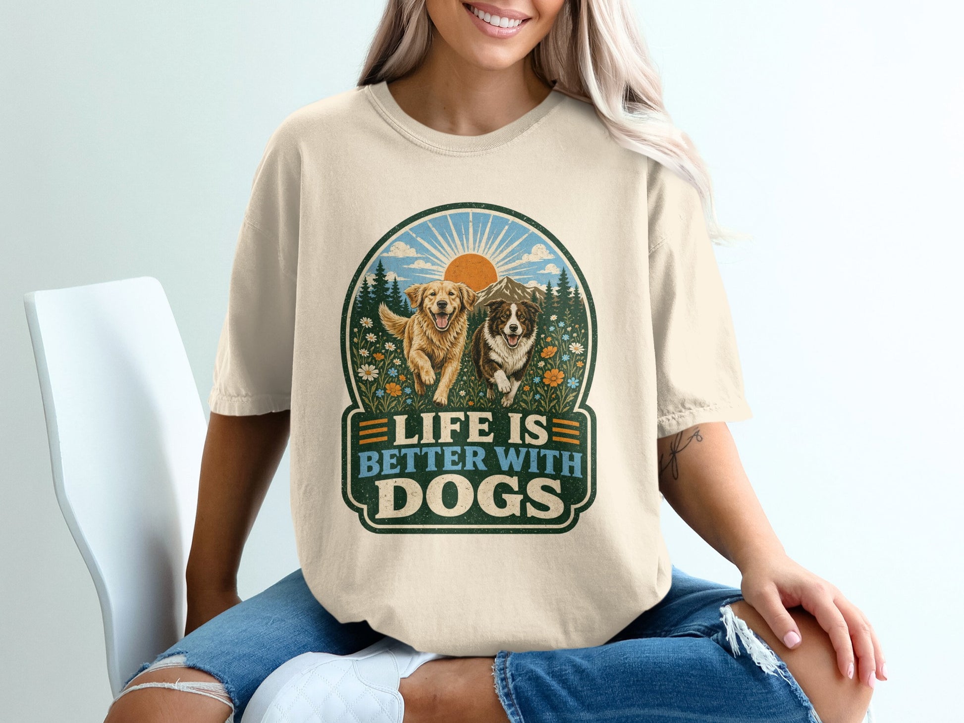Graphic tee with two dogs, mountains, and text "LIFE IS BETTER WITH DOGS."