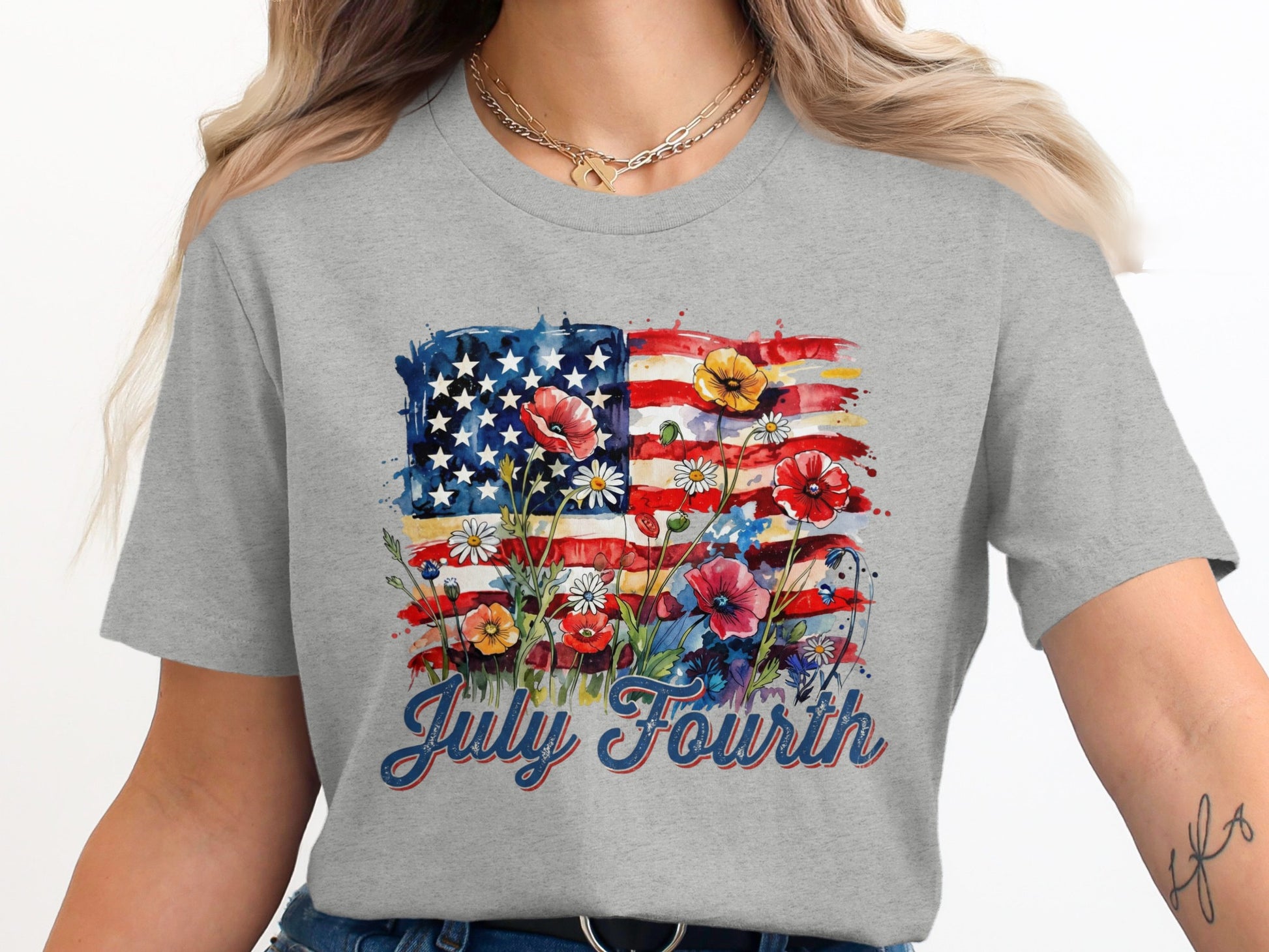 Gray t-shirt with watercolor American flag and wildflowers, "July Fourth" text.