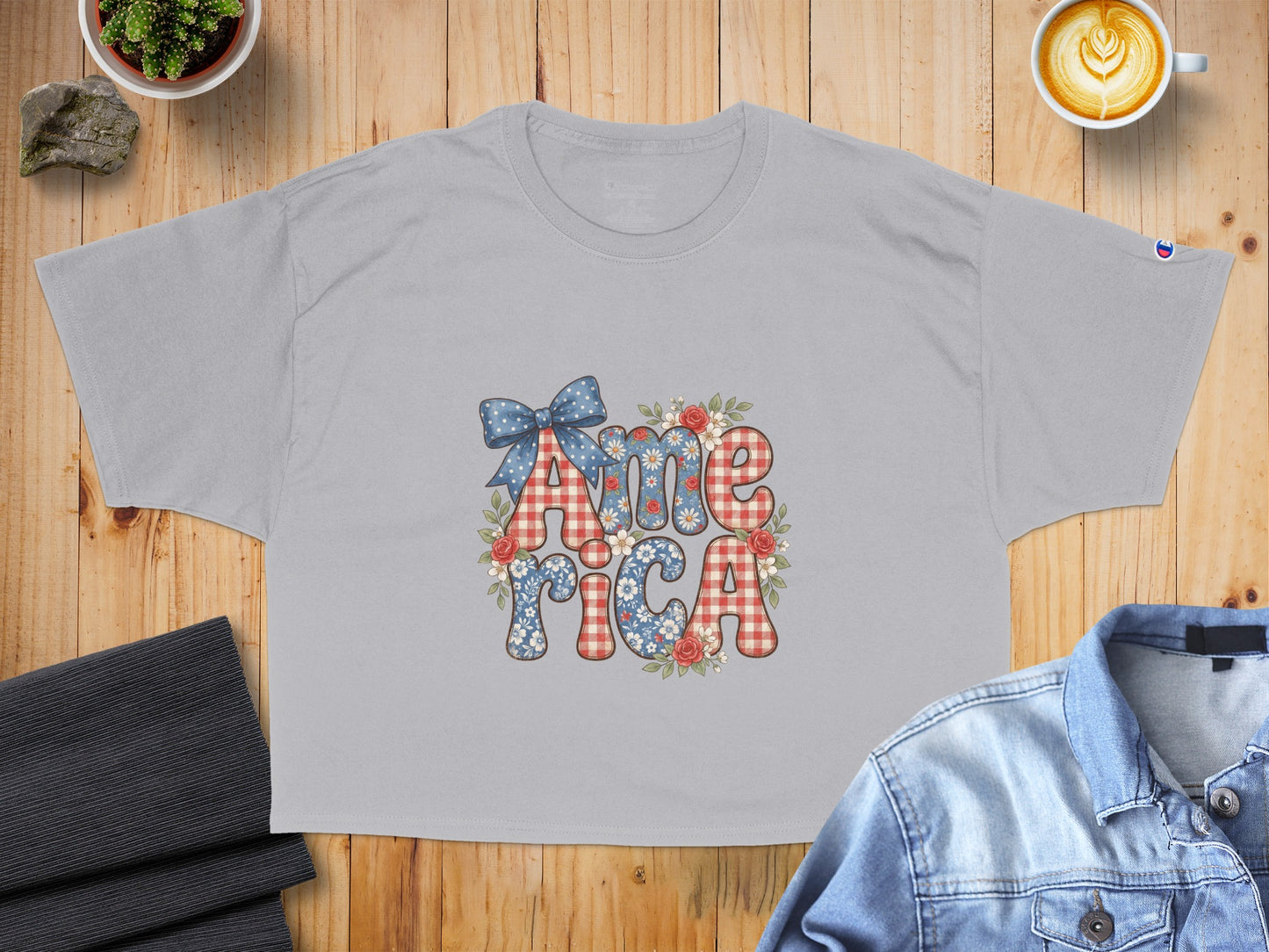 Gray t-shirt with "America" in patriotic patterned letters and flowers.
